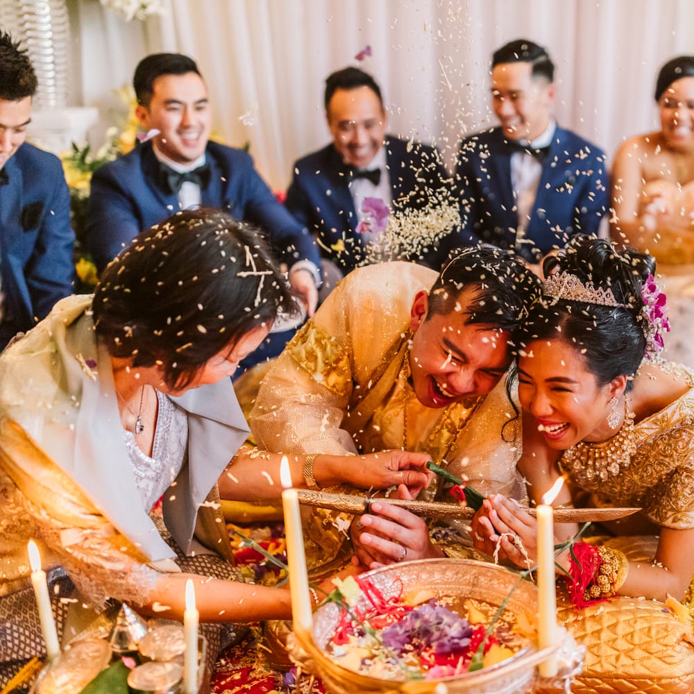 The bride and groom participate in a traditional ceremony, surrounded by the wedding party
