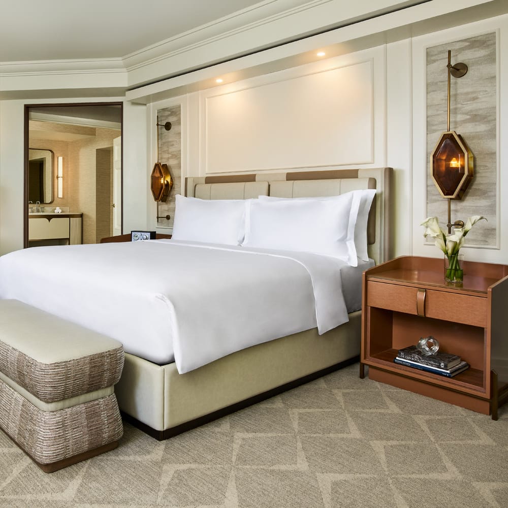 Explore the epitome of luxury in the Ritz-Carlton, Denver's Presidential Suite, featuring a plush king bed, elegant furnishings, and refined decor, perfect for a sophisticated stay in the heart of the city