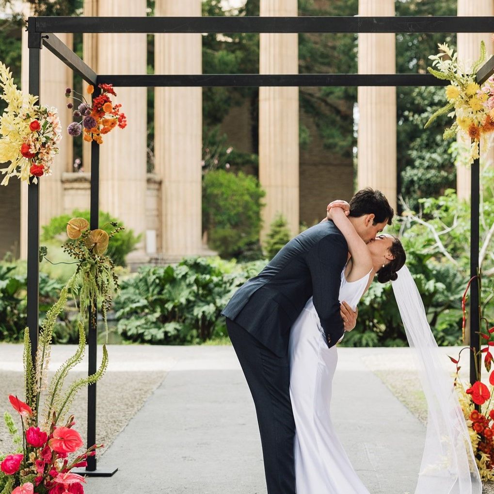 Bright colored florals decorate ecclectic wedding held under the roman rotunda at the Palace of Fine Arts