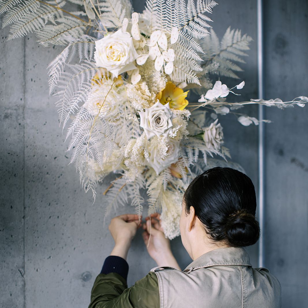 Chas Thompson of Wildflower Portland works with a floral installation of her design.