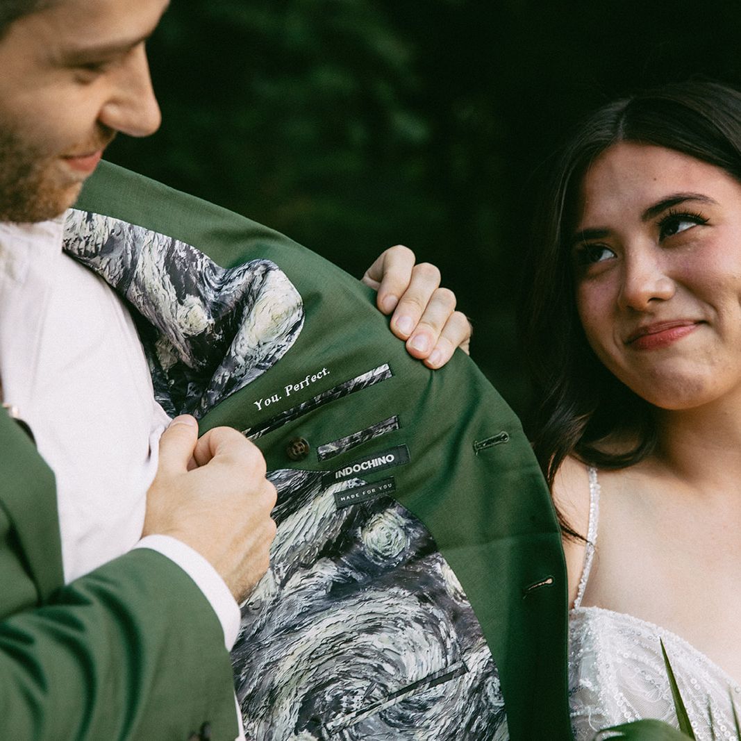 Garrett Shows of his Suit with Courtney Smiling