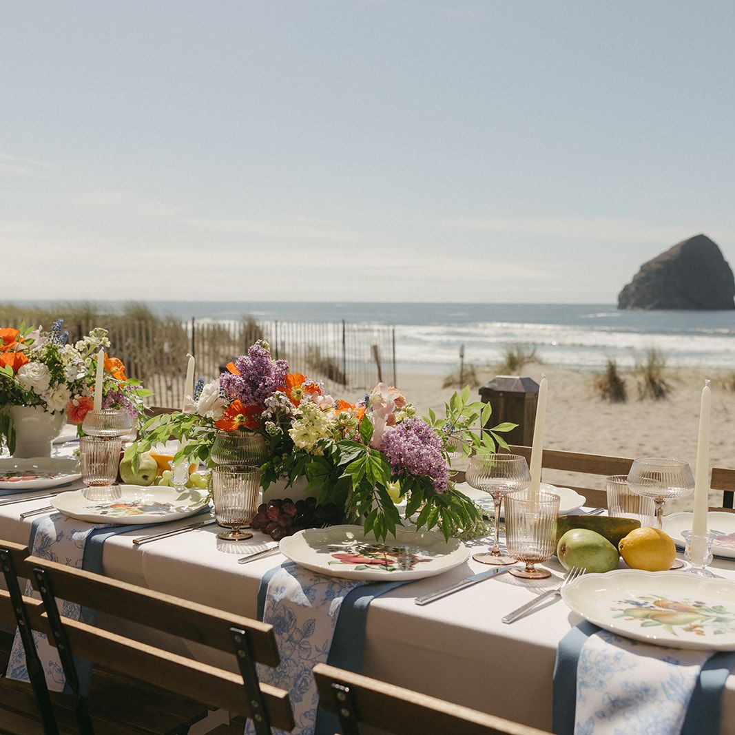 Minimal beach reception scene with bright florals and fruit accents at Pelican Brewing