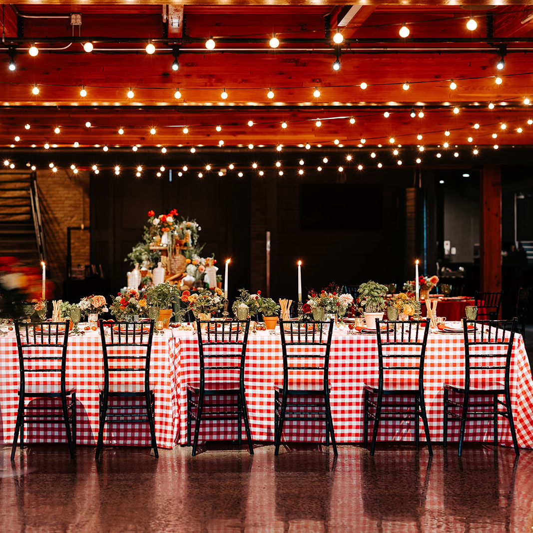 Cozy Italian restaurant-inspired reception featuring candlelight and produce infused tablescape at Essence Event Center