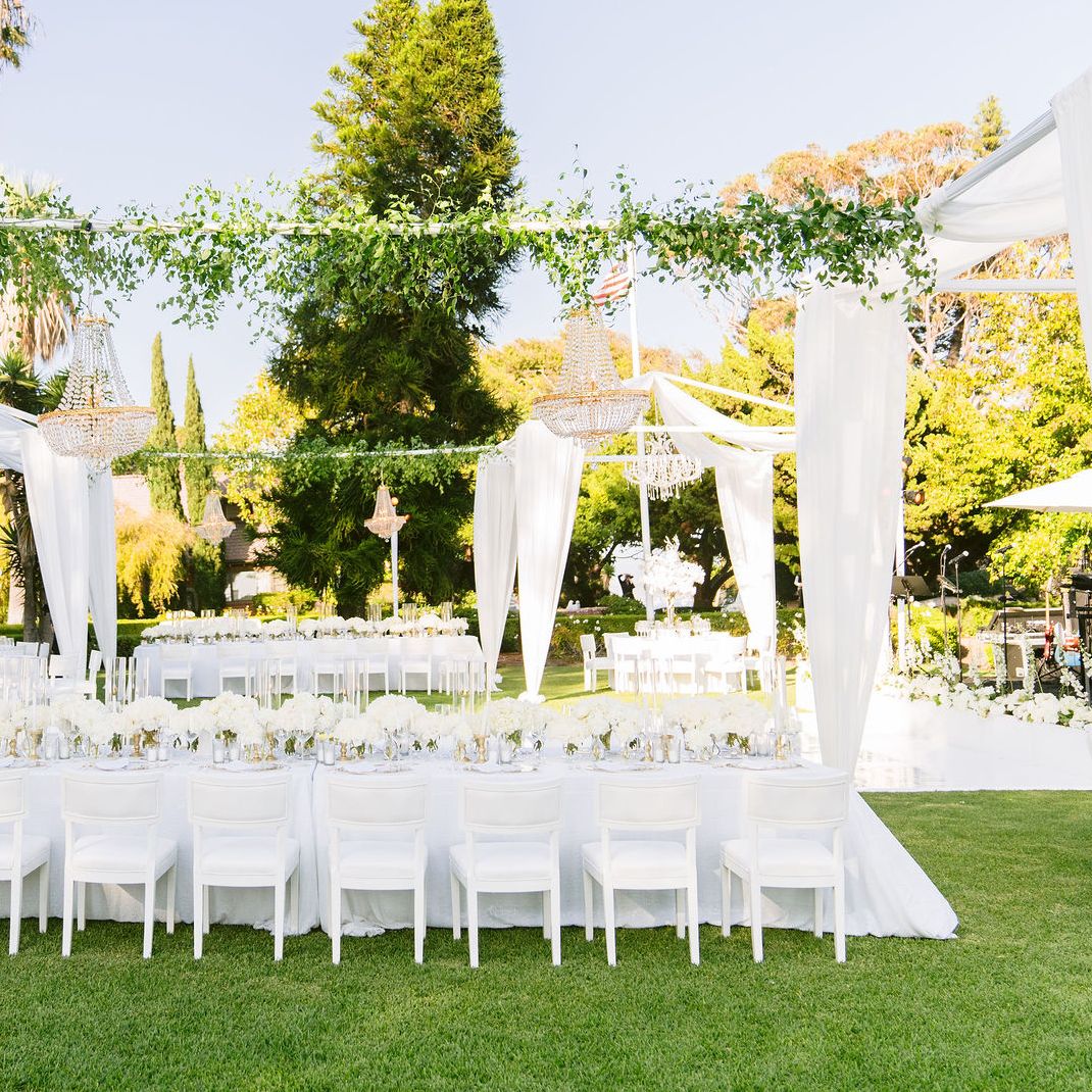 Discover how Tiana Belle and Todd Bryant’s ethereal wedding at Gulls Way featured a stunning all-white theme with colorful floral accents, a Zuhair Murad gown, and magical touches like fire dancers and personalized vows.