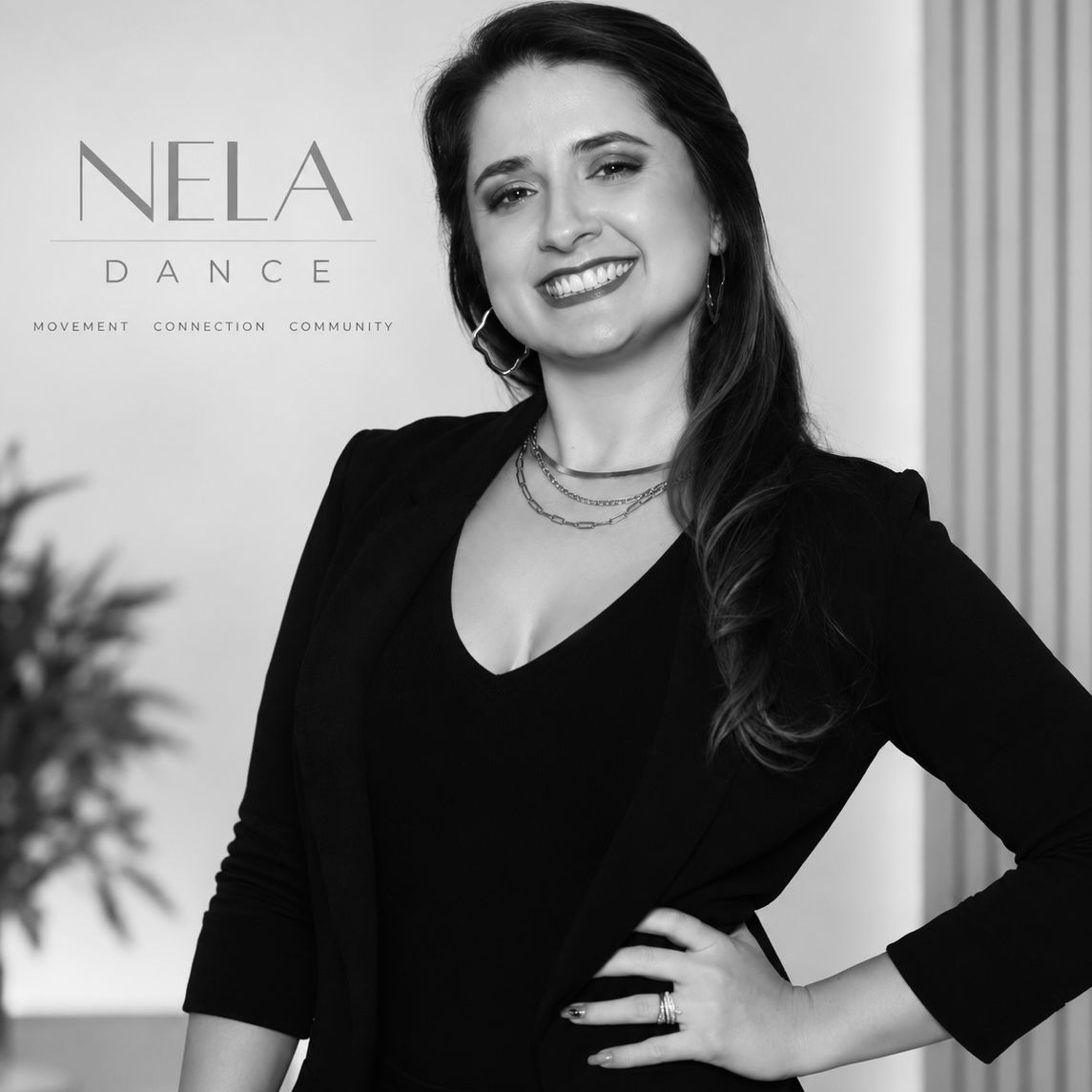 Black-and-white portrait of Nela Menéndez, owner of Nela Dance, smiling beside her dance studio's logo.
