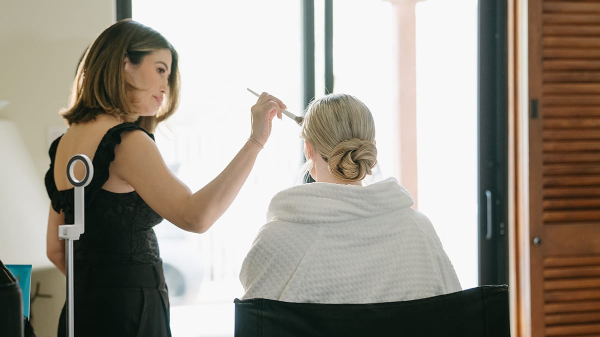 Emily Gleeson Bridal Artistry Collective doing bride with bun's makeup 