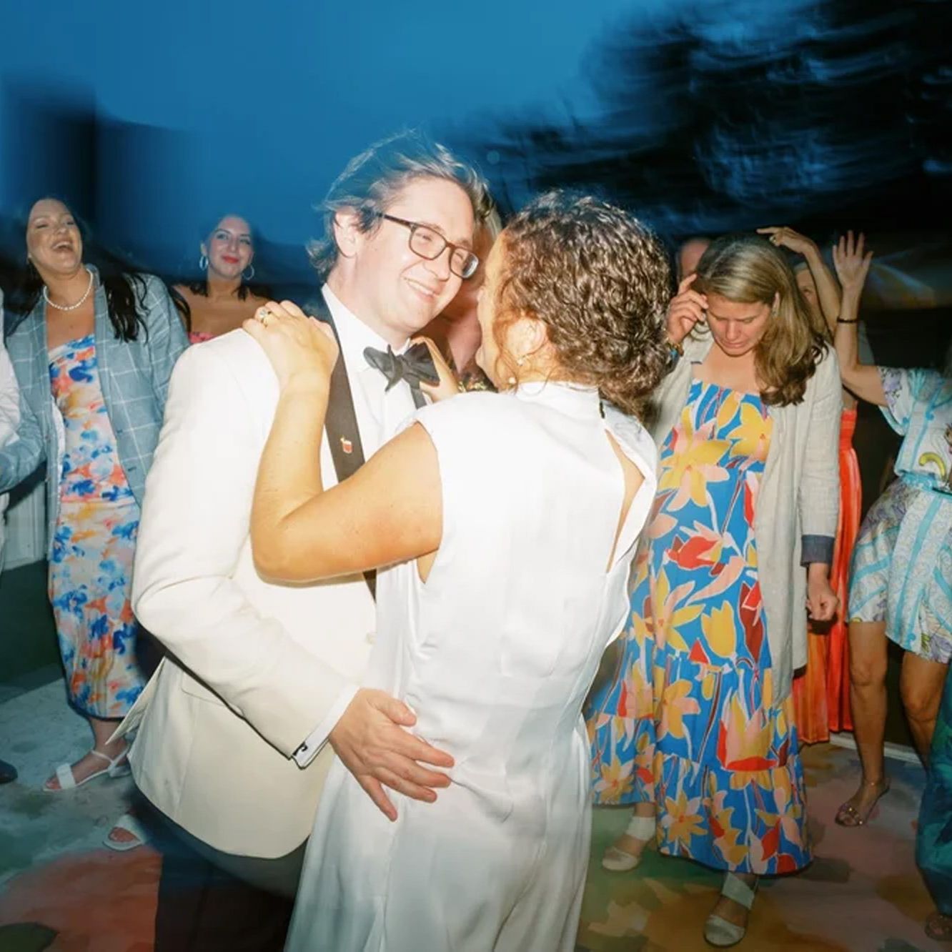 Bride and groom embrace on the dancefloor of their wedding day at the Admiral's House