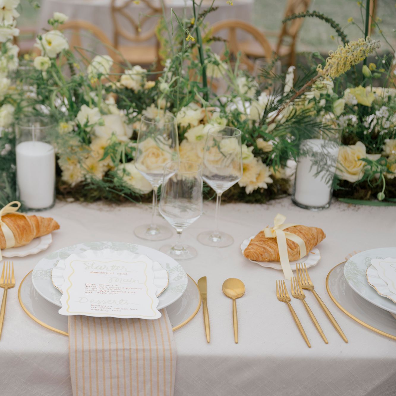Butter yellow tablescape featuring lush florals and croissant details at Zenia