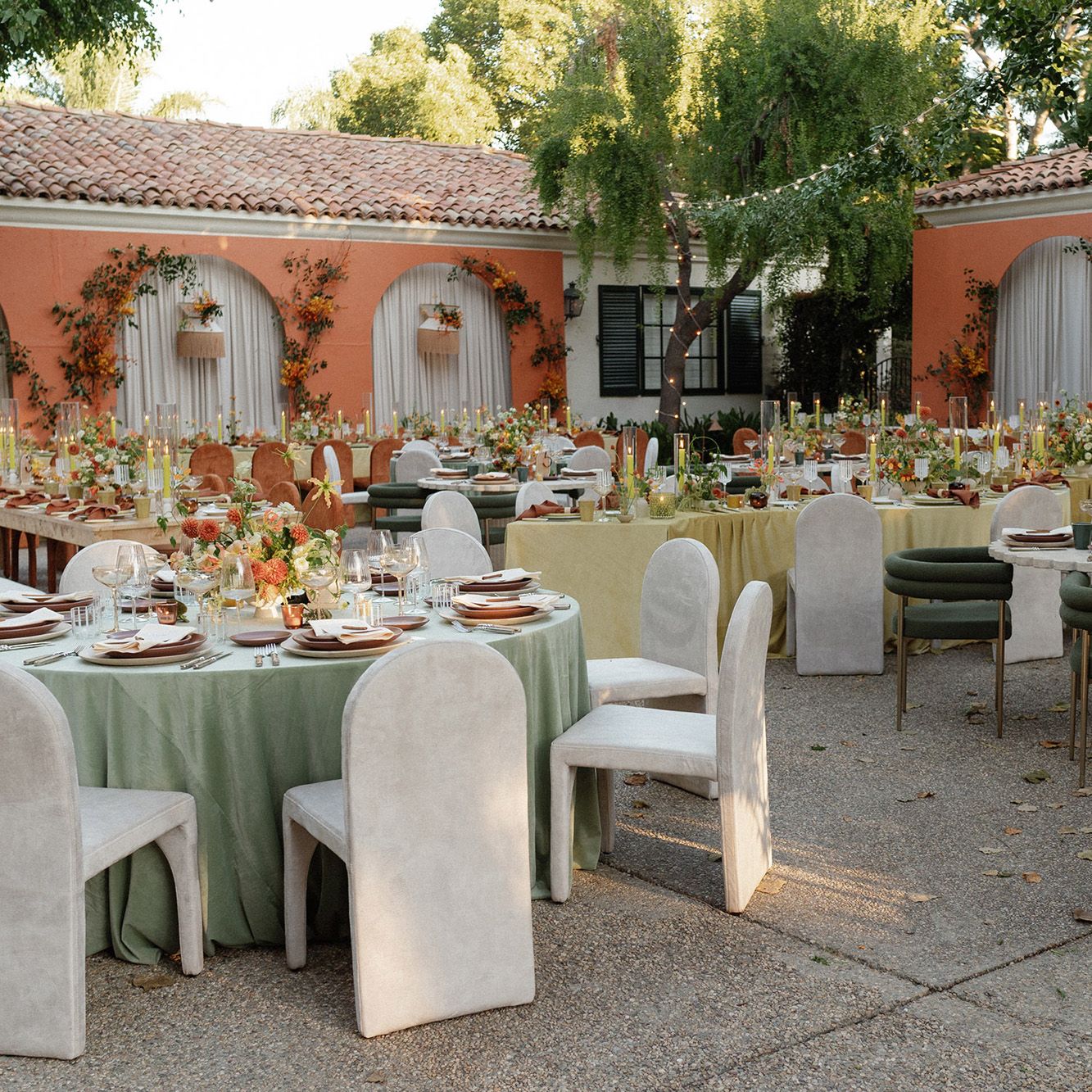 Mid-Century Modern reception scene featuring bold orange hues and serpentine table structures