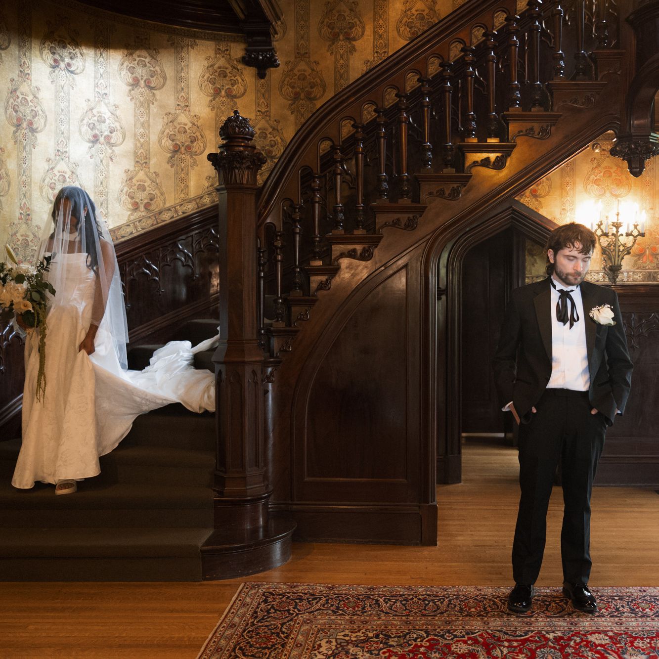 Bride descends staircase at Joslyn Castle to meet her groom in first look reveal