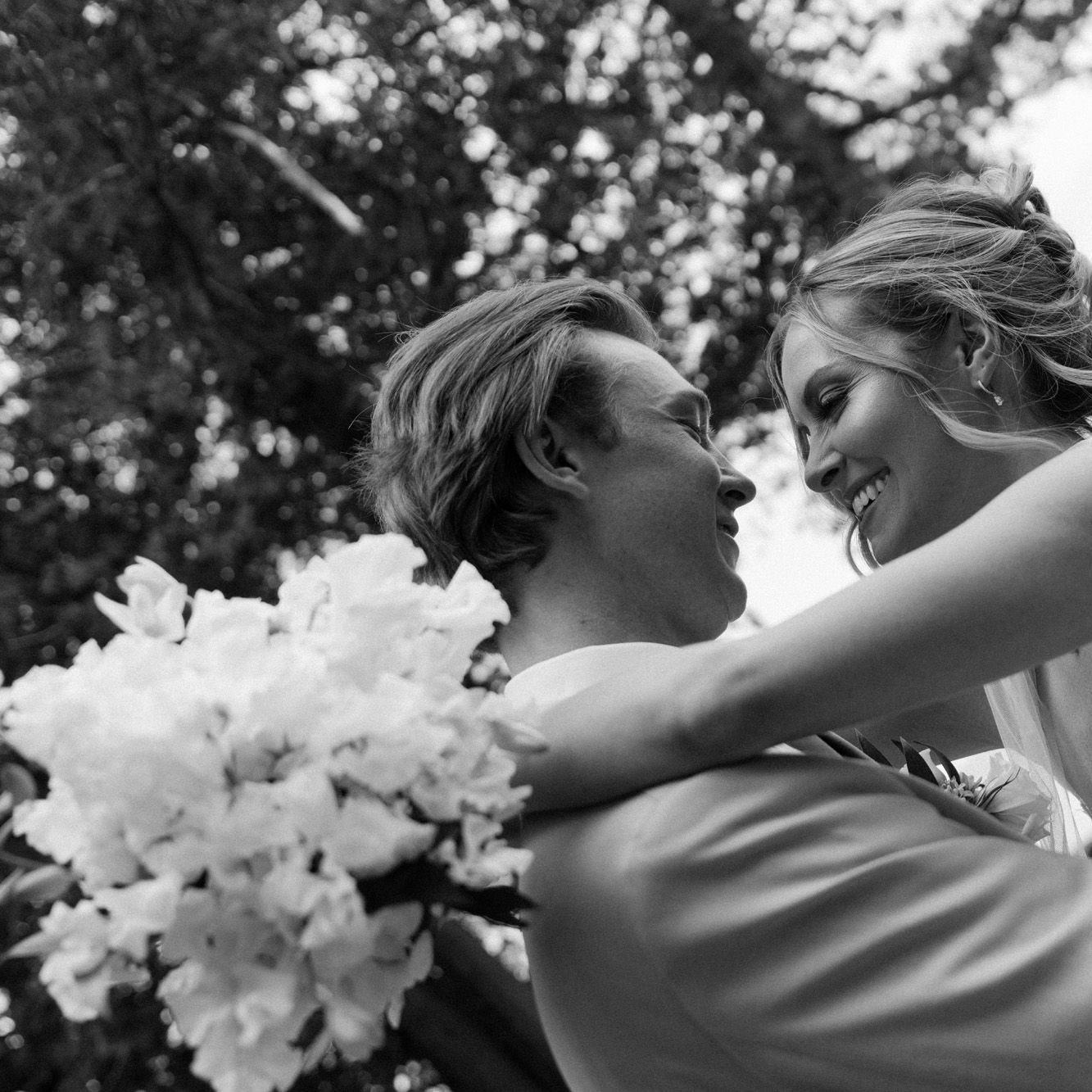 Bride and groom embrace on the grounds of Alpine Resort