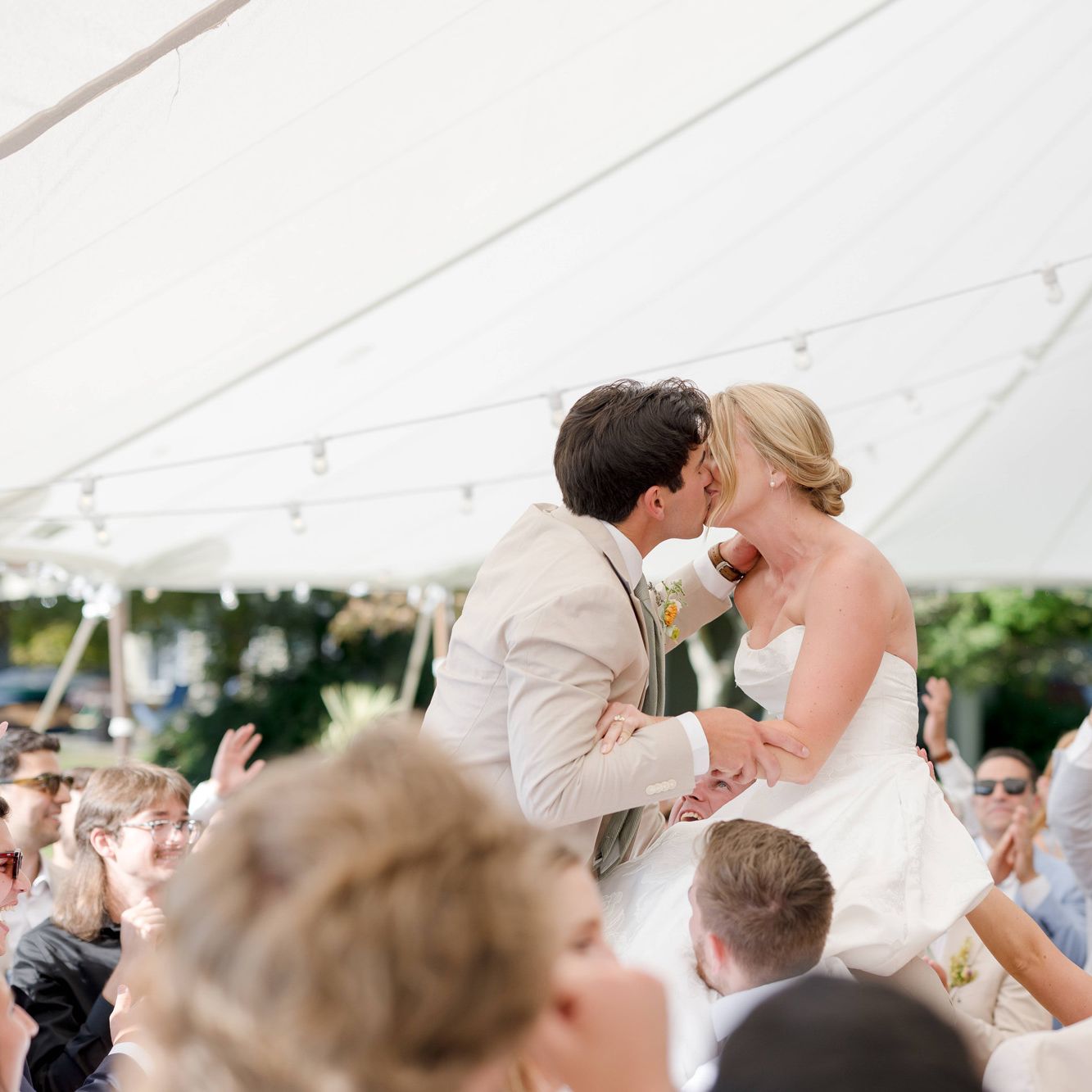 Courtney and Alden share a kiss as they are lifted into the air on the dance floor