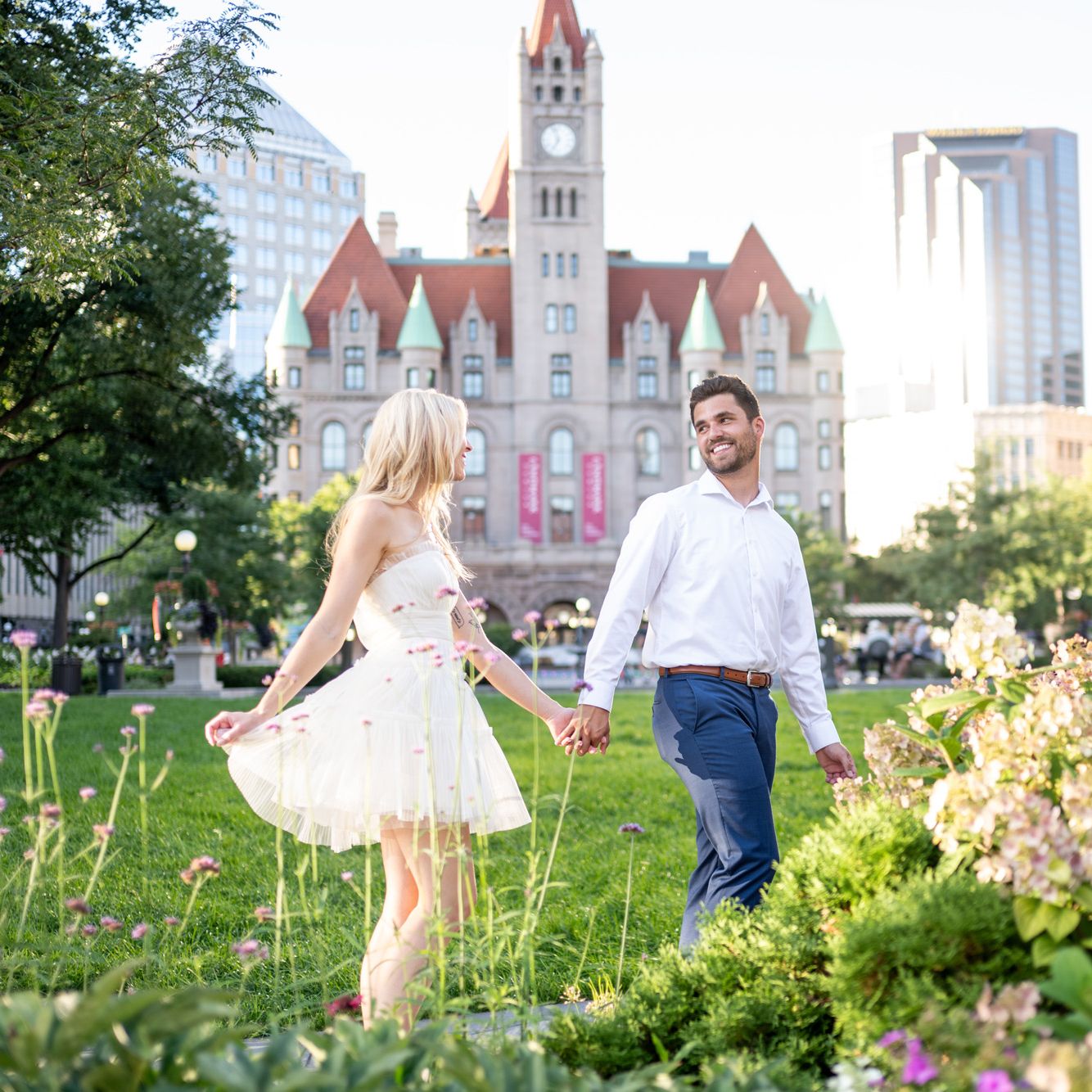 Katie and Zachary celebrate their engagement by prancing around the park in front of Landmark Center in St. Paul