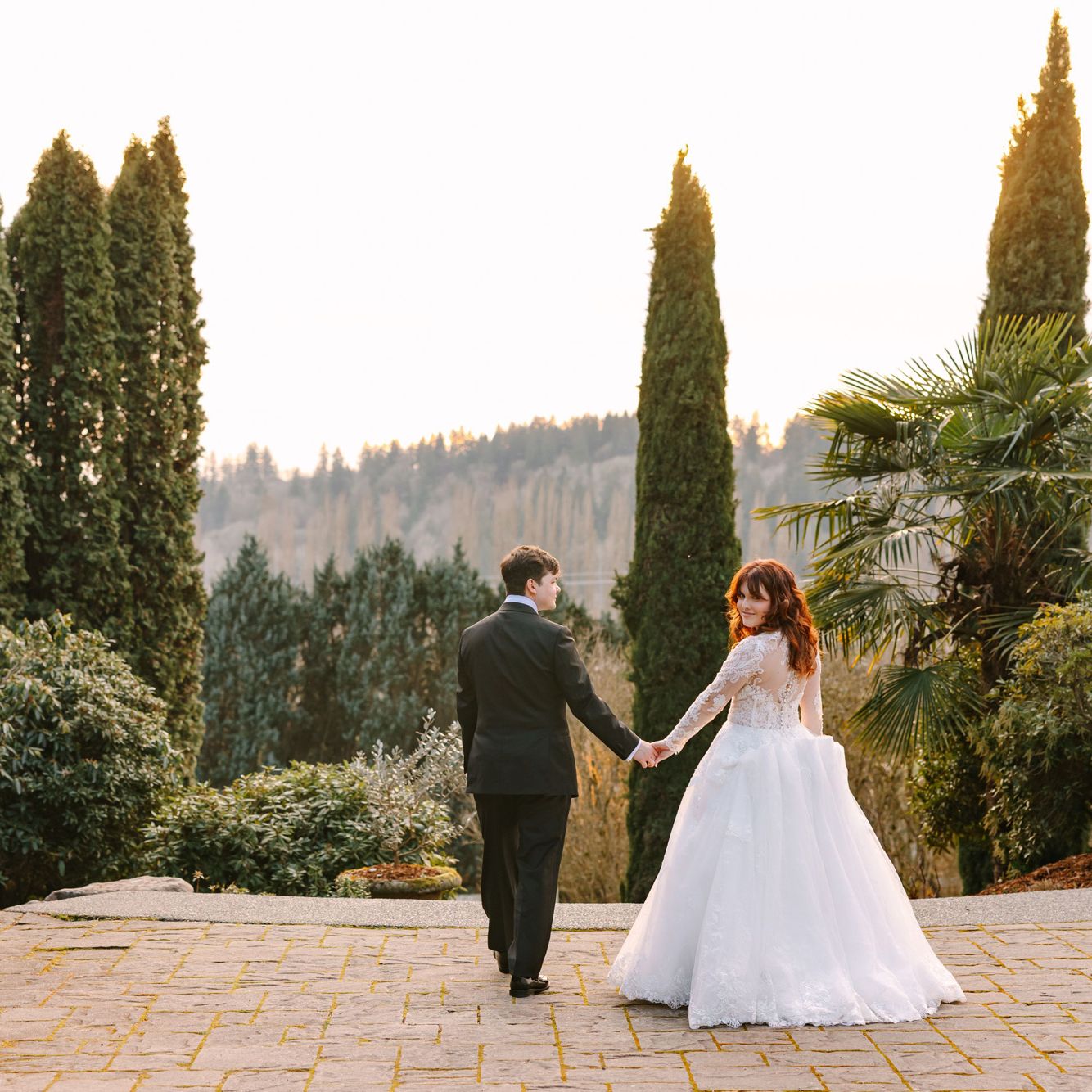 Lilly and Michael walk the grounds of Chateau Lill on their wedding day