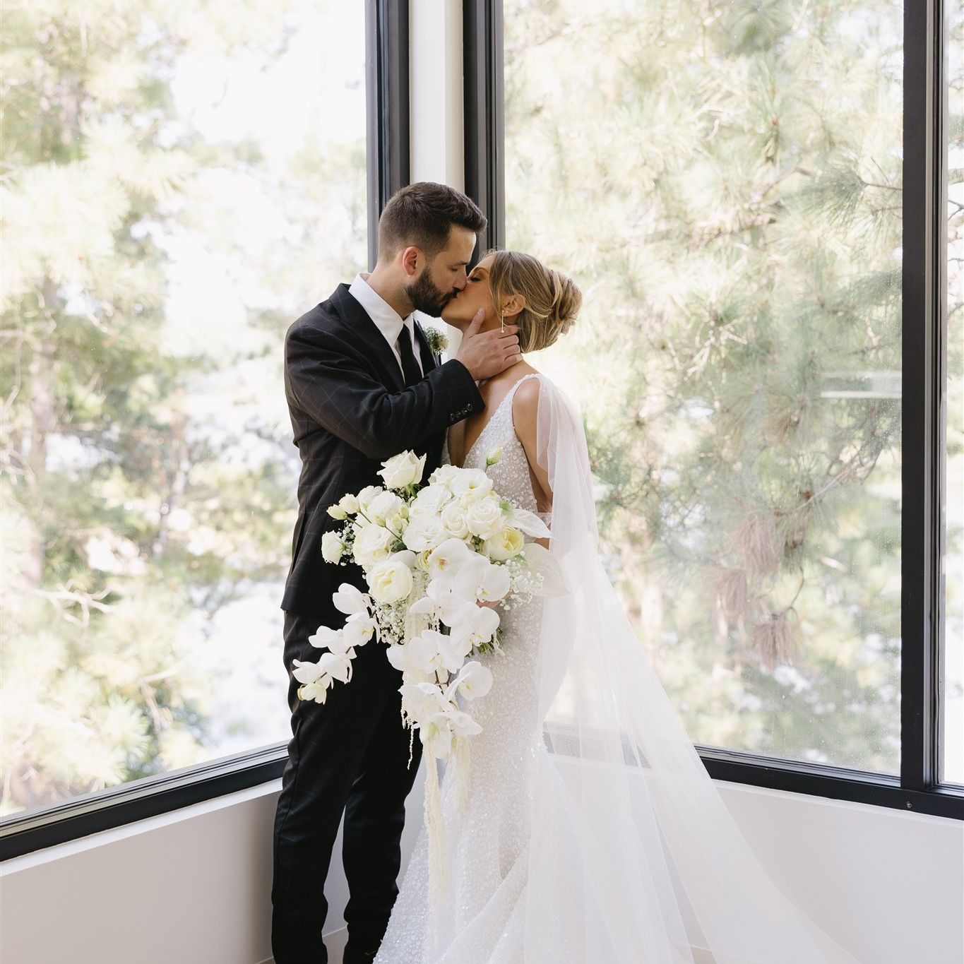 Bride and groom share kiss at modern venue