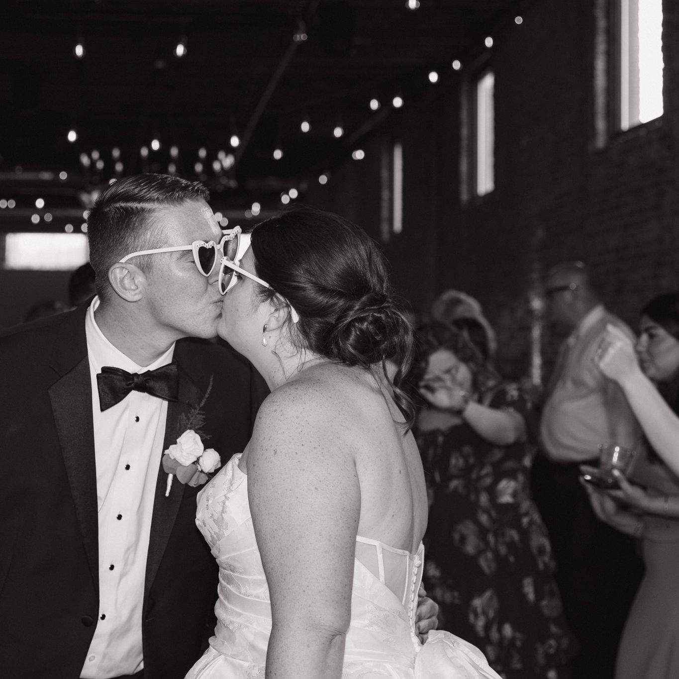 Bride and groom share a kiss during their reception at Mercantile Hall