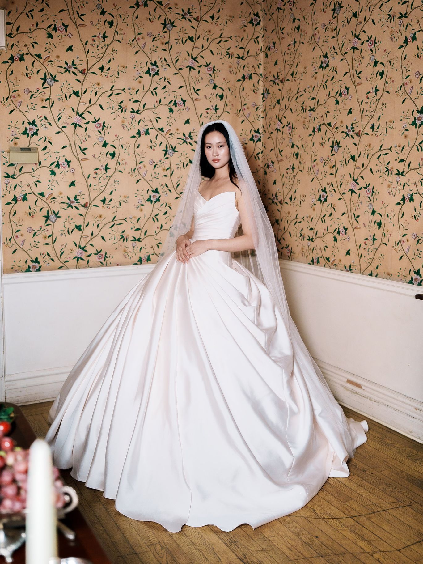 Soul Mates Bridal’s Marée d’Aphrodite wedding dress features a pleated bodice and full satin ball gown skirt, shown in a romantic draping trend roundup from New York Bridal Fashion Week.