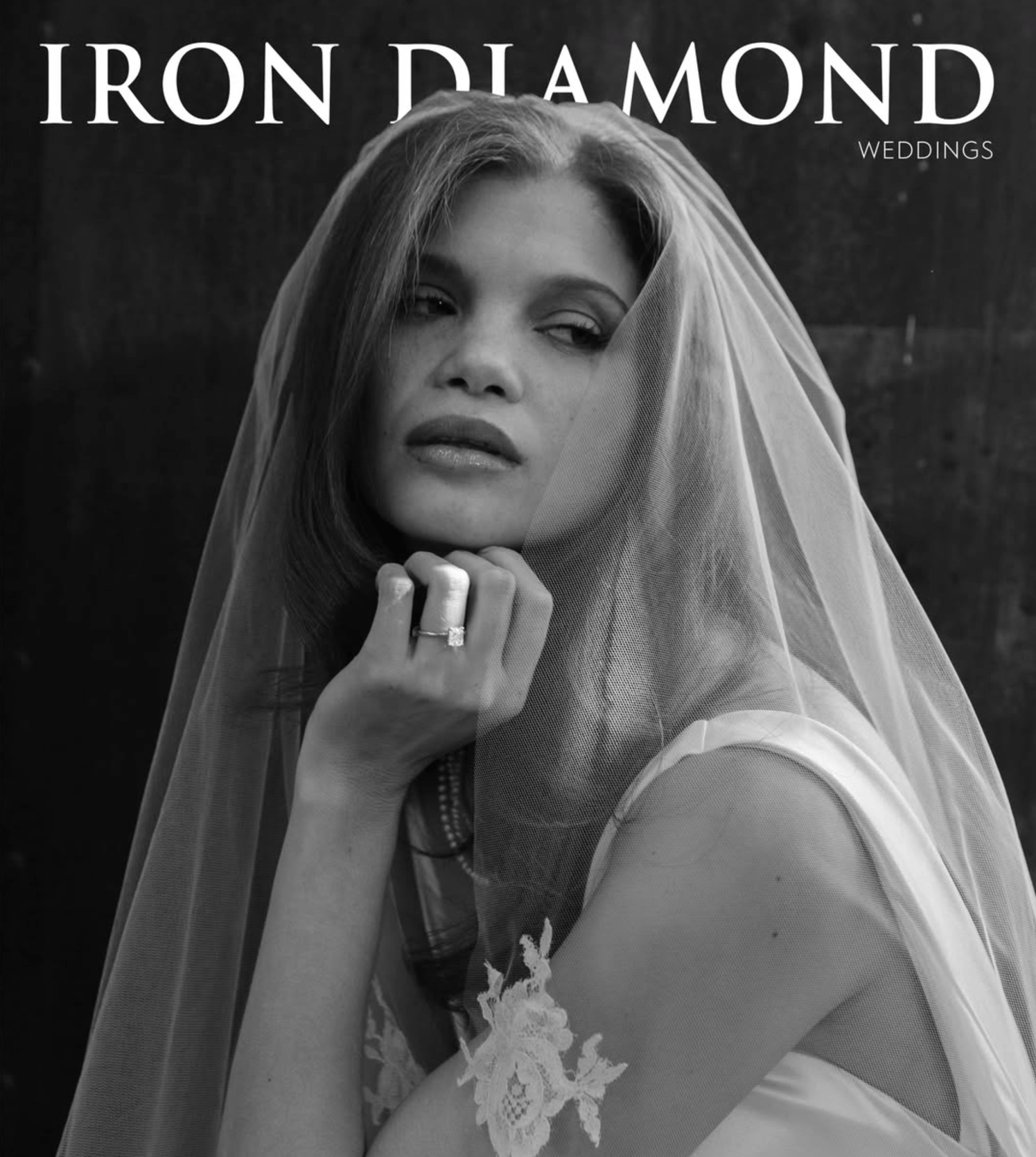 Black-and-white IRON DIAMOND Weddings magazine cover featuring a close-up bridal portrait of a woman wearing a sheer veil and diamond engagement ring, resting her chin on her hand.