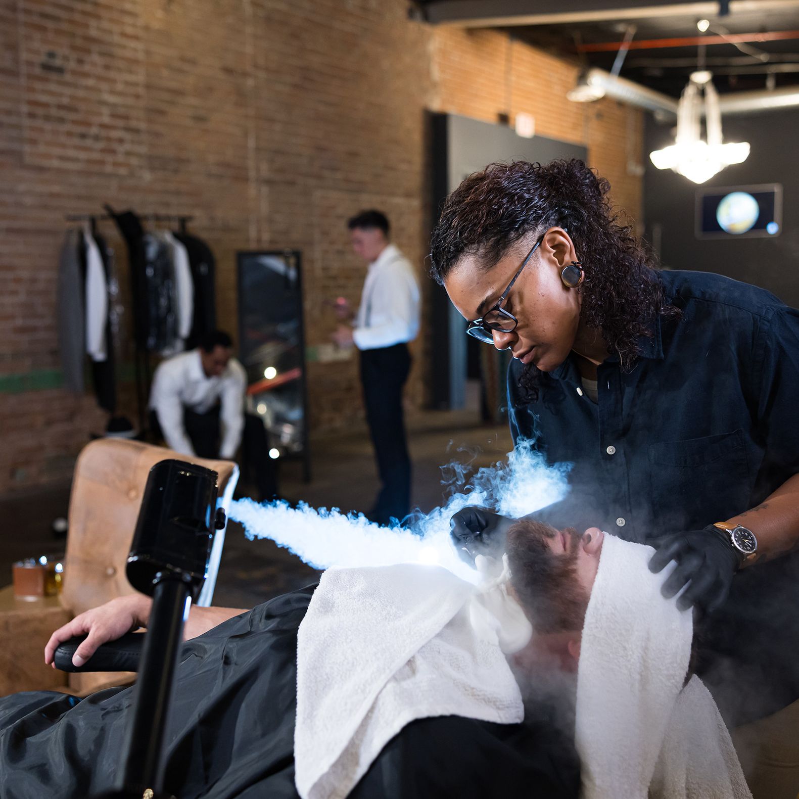Groom receives a steam facial treatment from JD Barba during a luxury wedding day grooming experience
