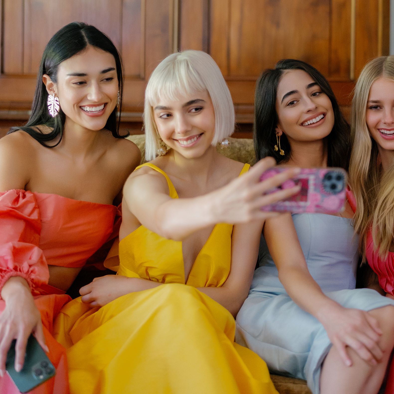 Models take a selfie in bright, summer-wedding-ready gowns by Watters