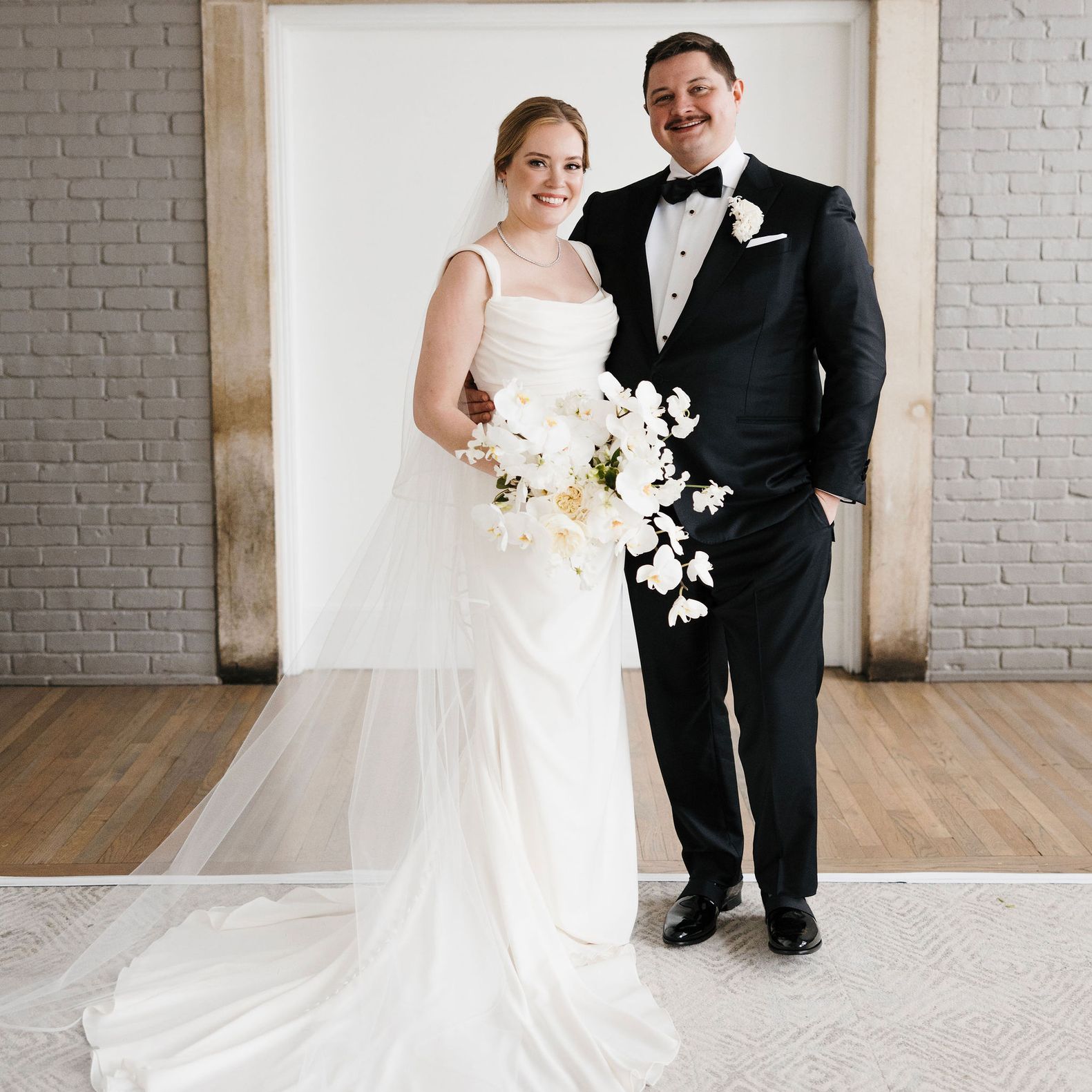 Paige and Johnnie standing in their wedding attire before heading to their ceremony.
