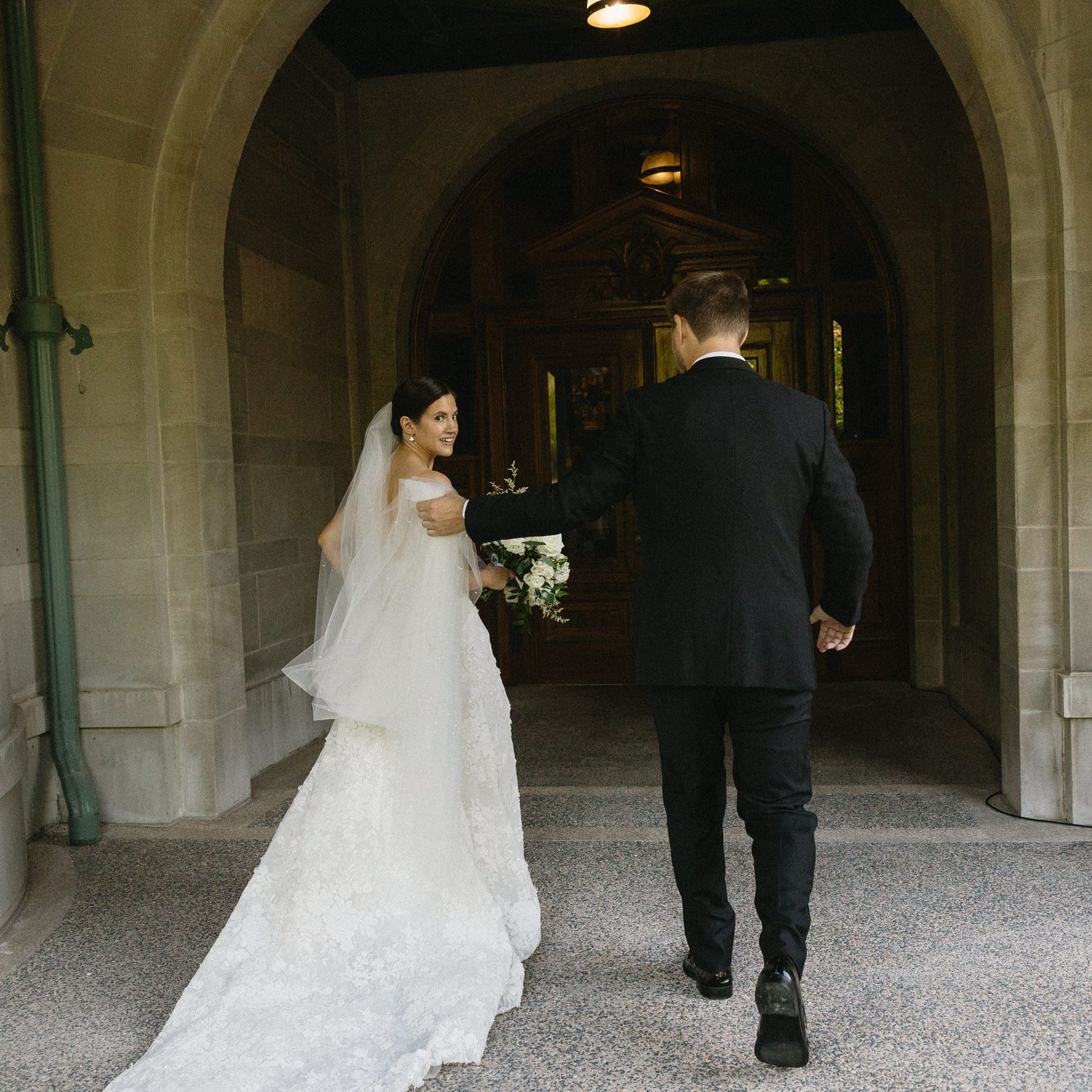 Bride and groom walking through the halls of the American Swedish Institute