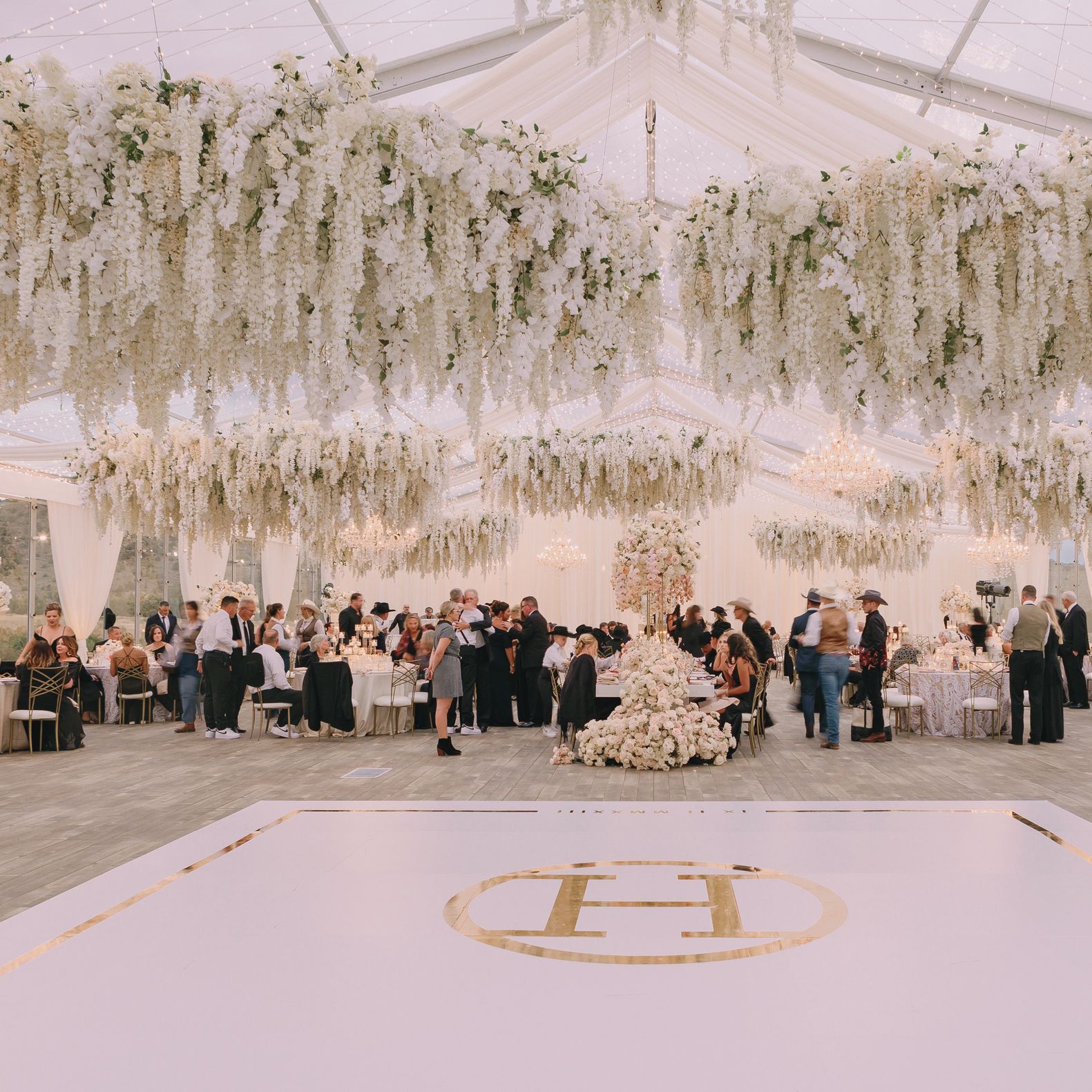 An Abundance of Dreamy White Florals Hang Over the Dance Floor at Brush Creek Ranch in Saratoga Wyoming