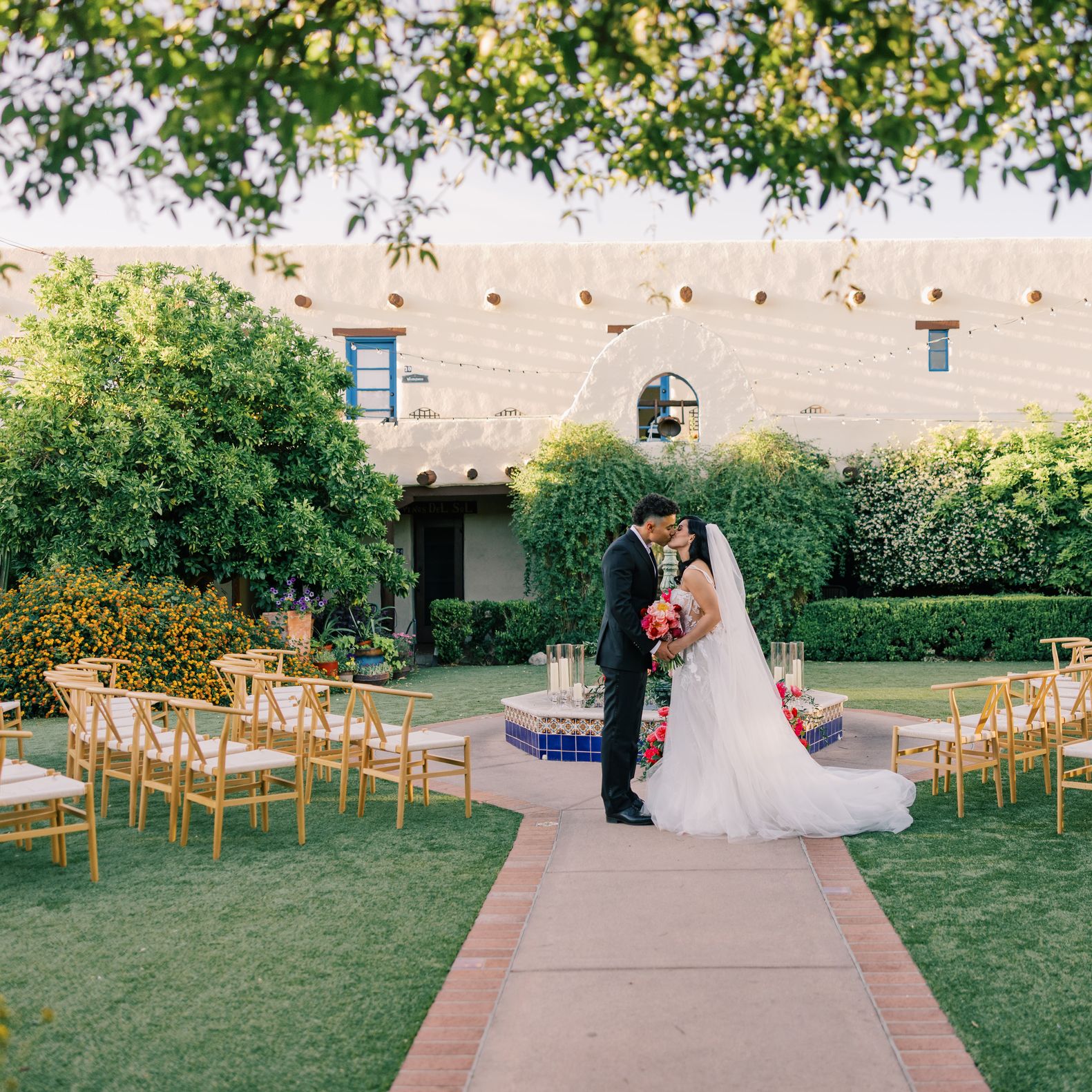 Models stand at the center of a circlular ceremony set-up in romantic editorial at Hacienda del Sol