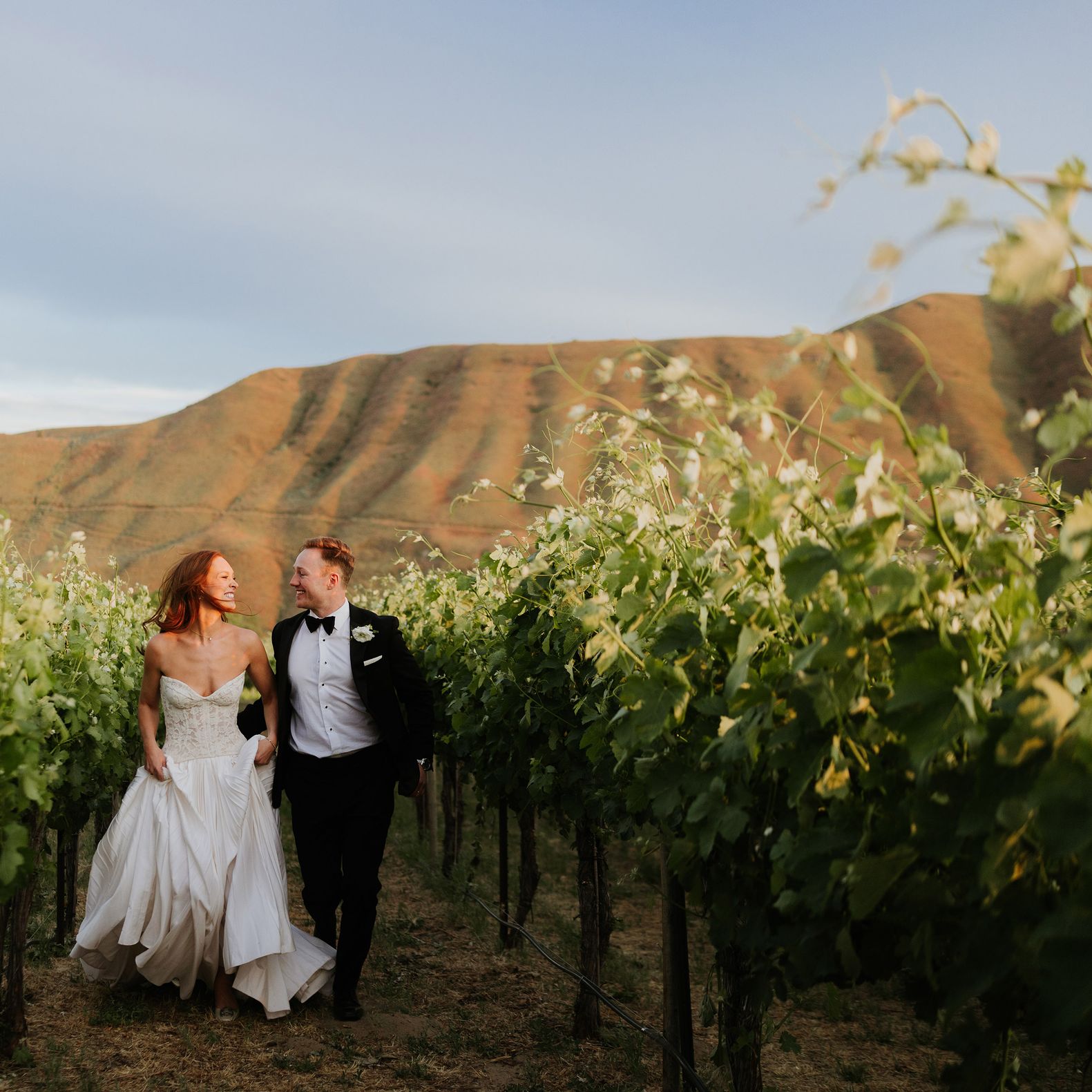 Lauren and Braedon walk on the grounds of a private estate on their wedding day