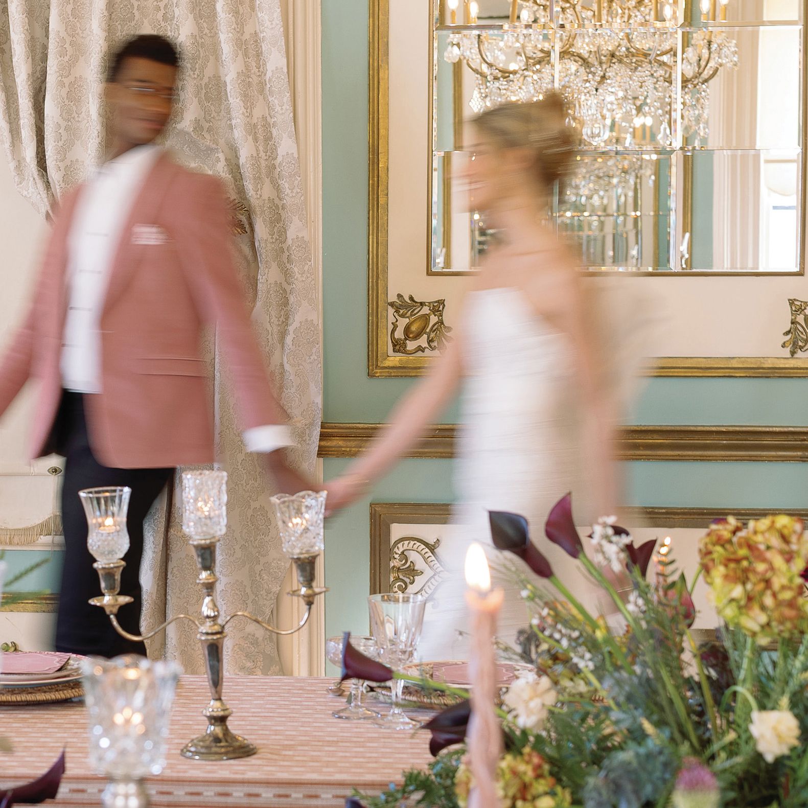 Models walk hand in hand amidst Ralph Lauren-inspired reception scene at Maxwell Mansion