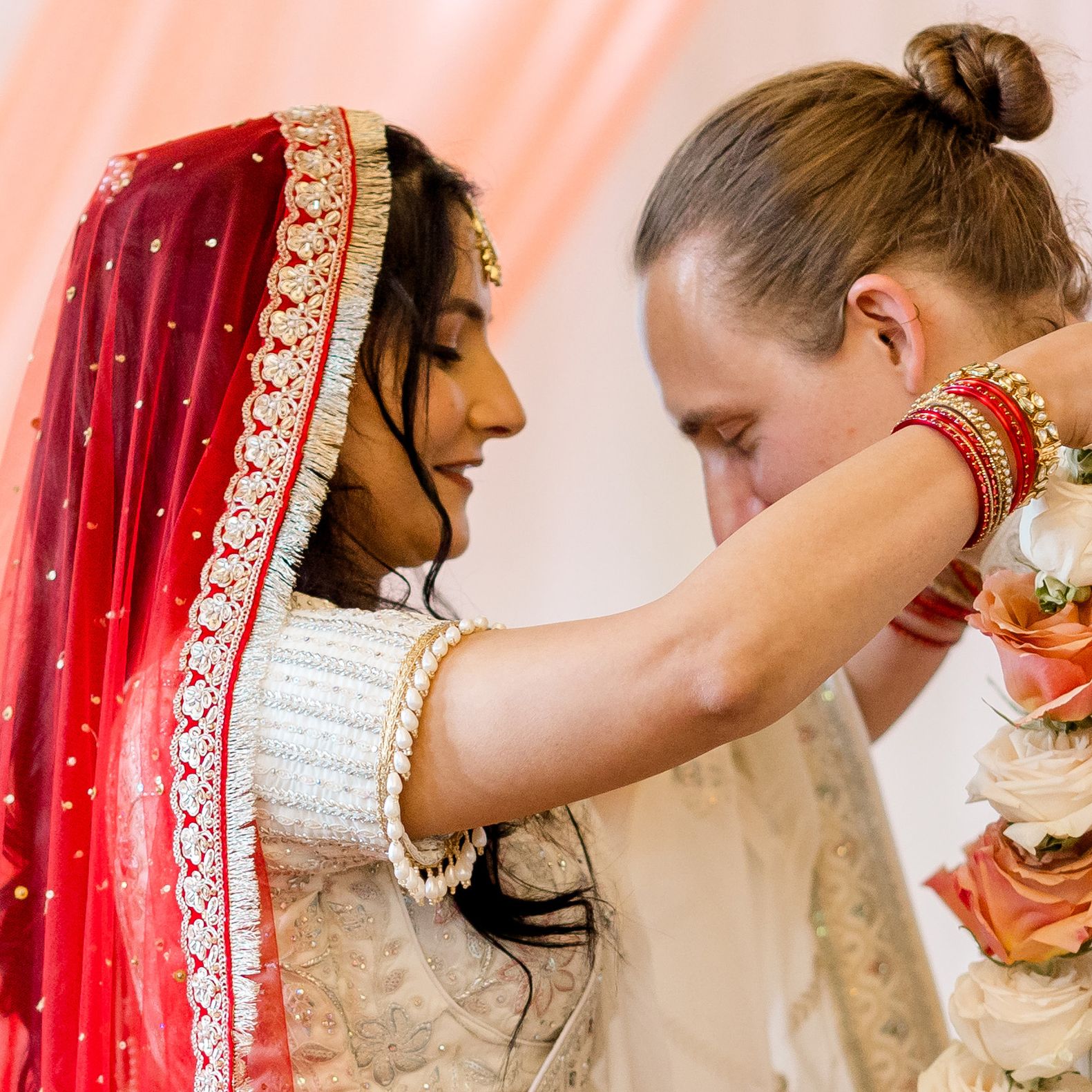 Shipra places a garland around Grant's neck during wedding ceremony