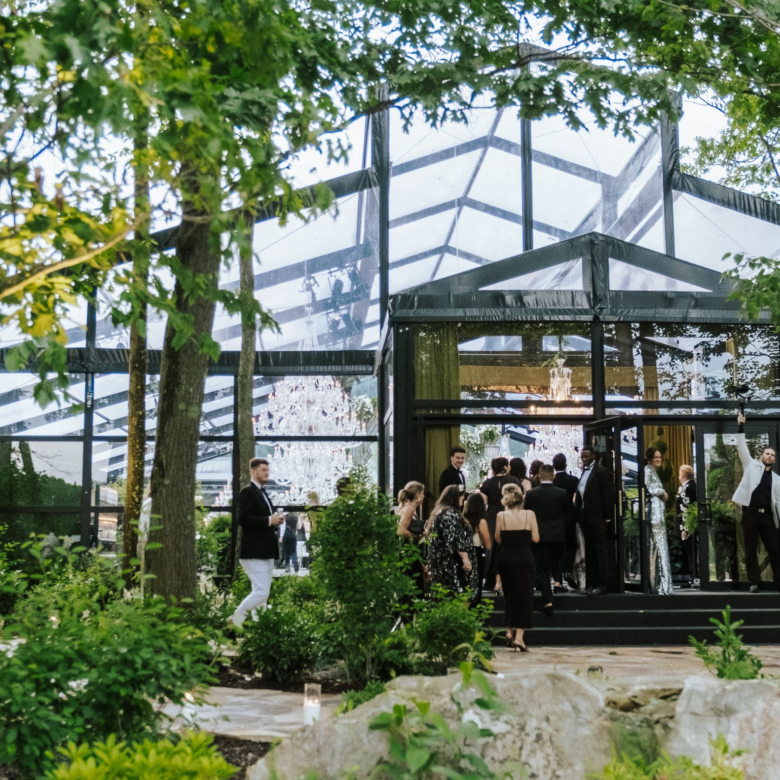 Guests file in to a greenhouse-style venue