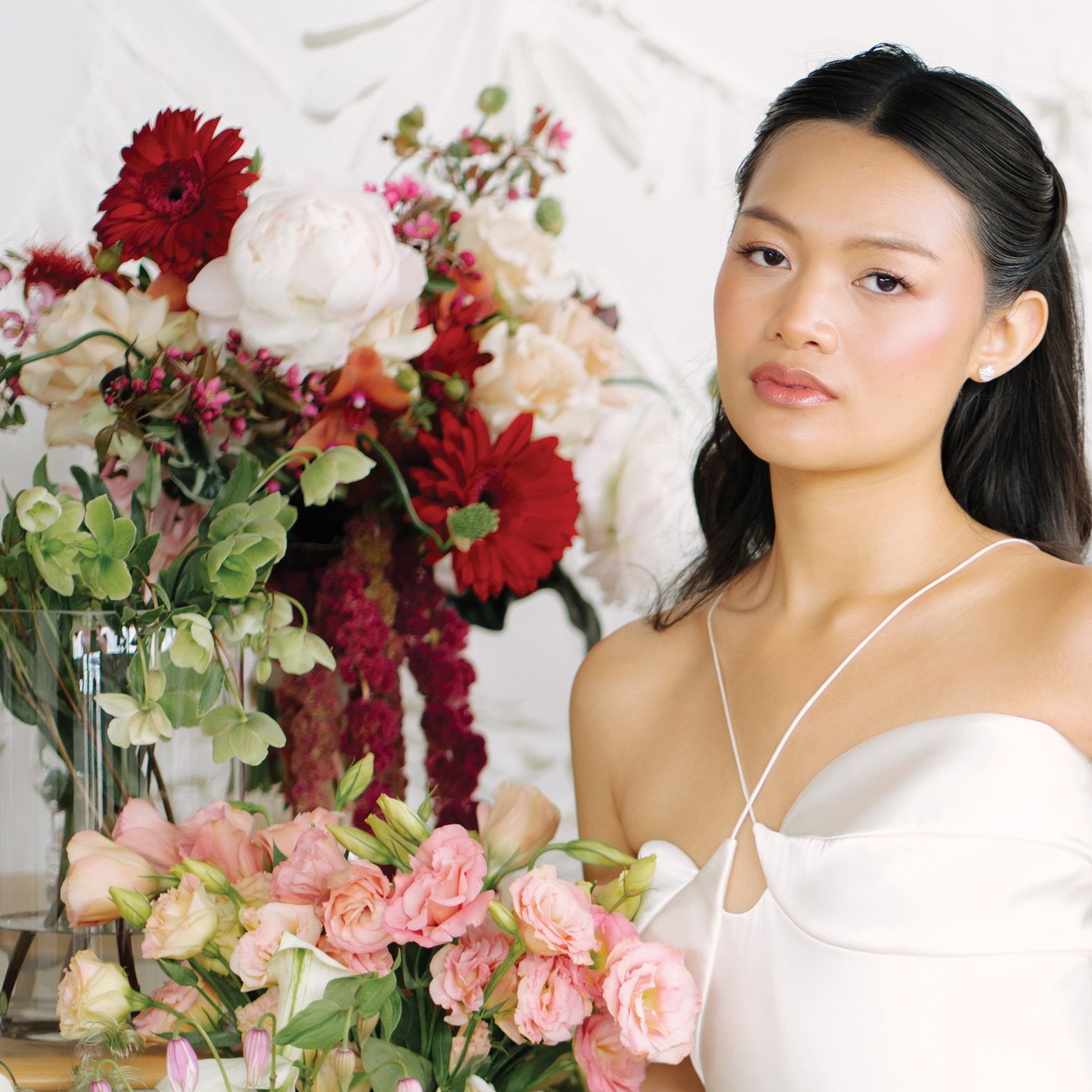 Model poses surrounded by a variety of blooms