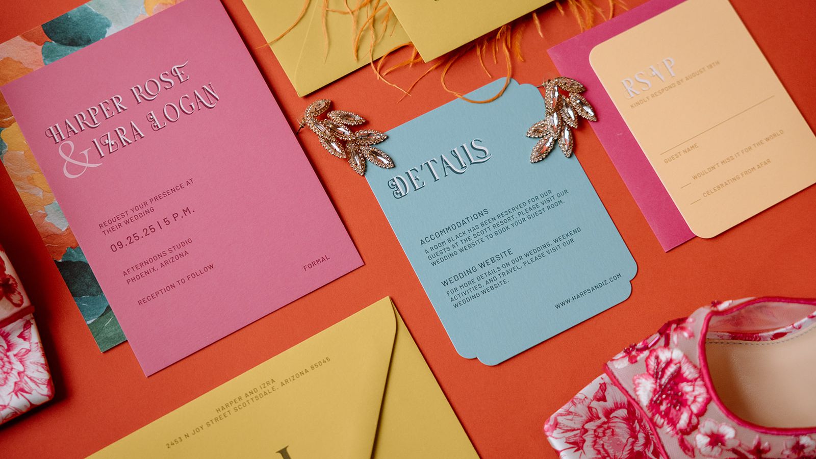 Colorful maximalist wedding invitation suite in pink, blue and yellow paired with statement earrings and floral heels