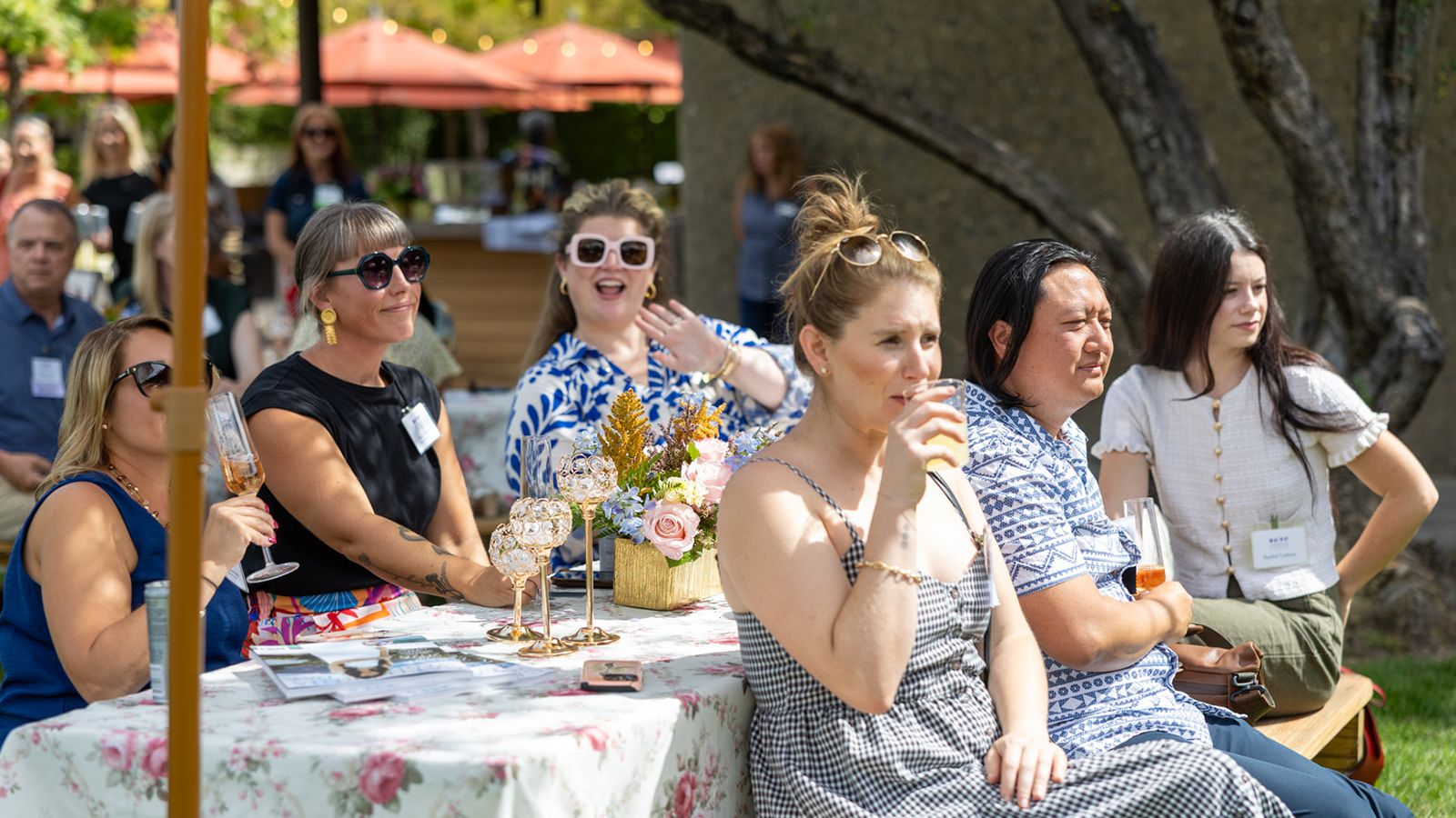 Guests seated at an outdoor table during the ILEA Napa-Sonoma event