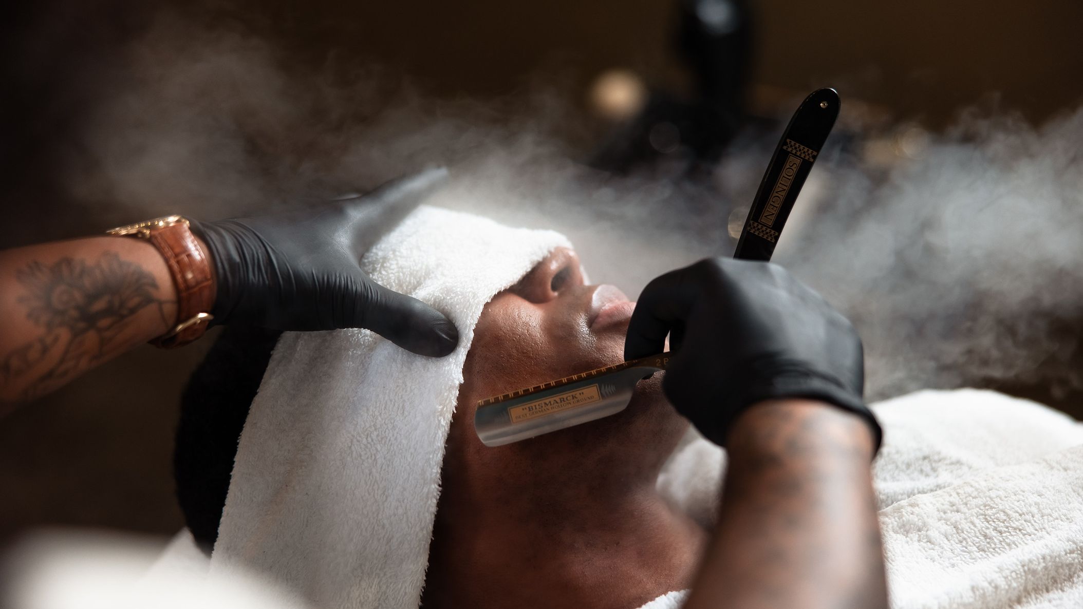 Groom receives a hot towel straight razor shave from JD Barba as part of a luxury wedding day grooming experience