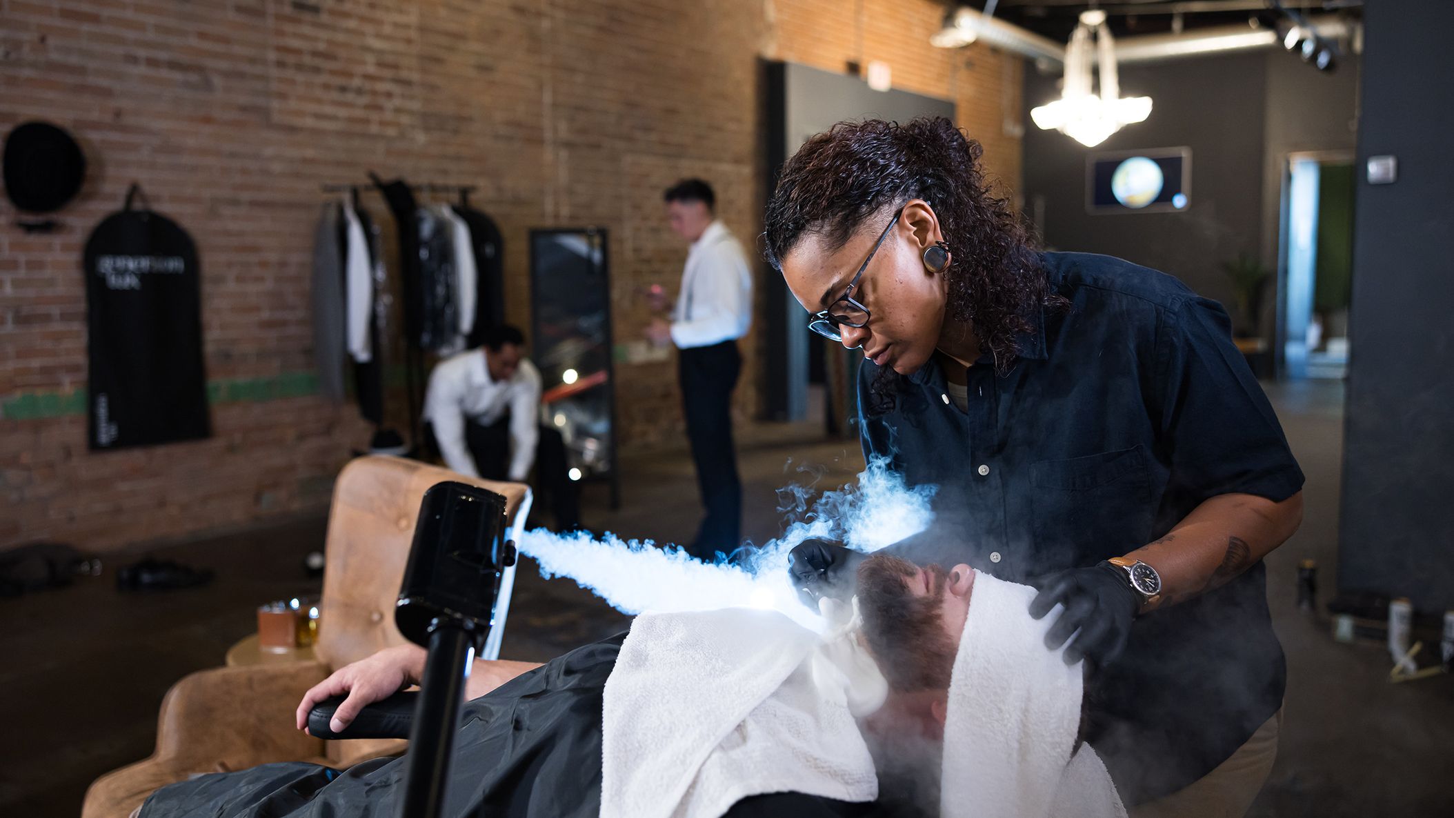 Groom receives a steam facial treatment from JD Barba during a luxury wedding day grooming experience