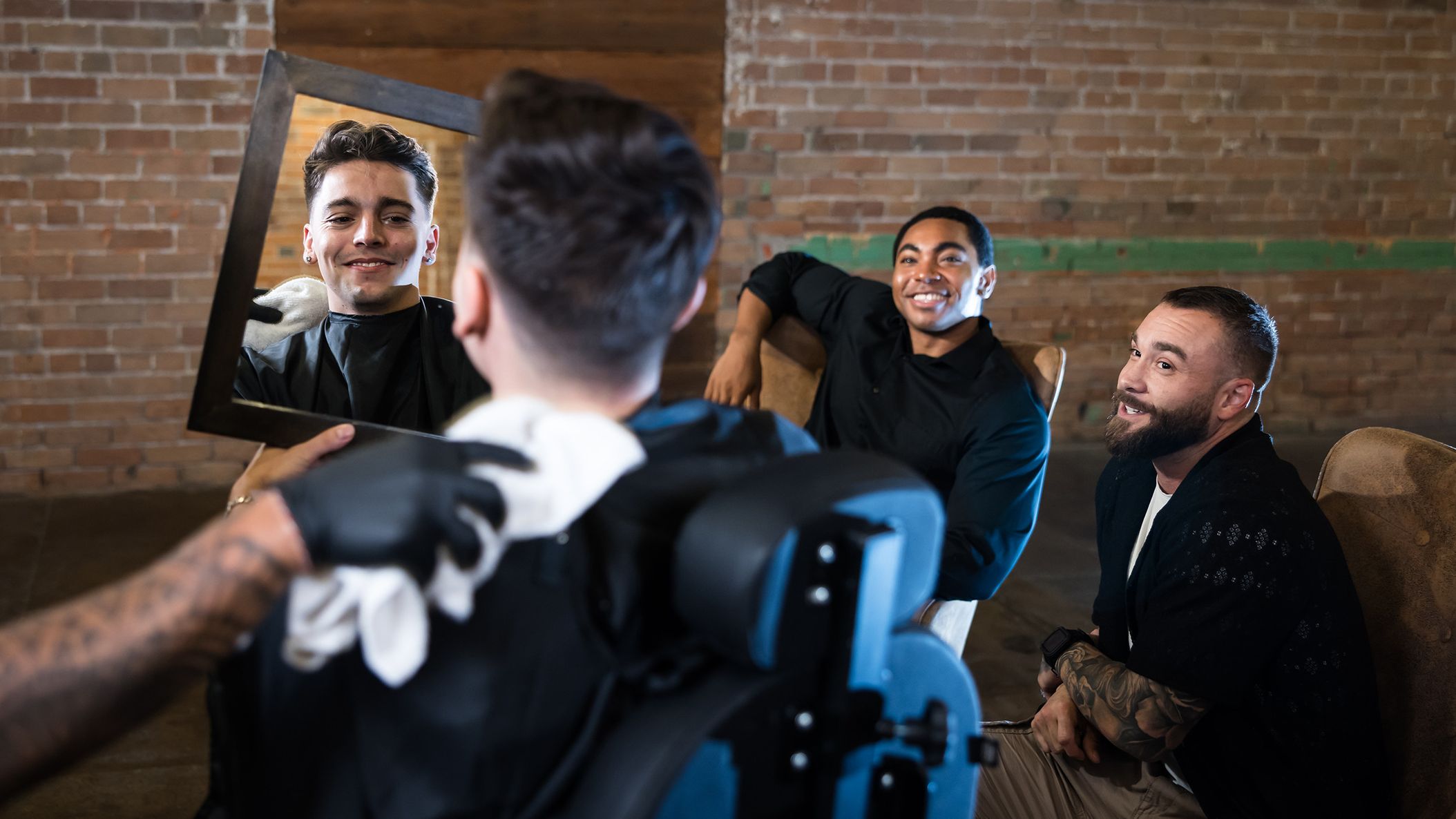 Groom enjoys a JD Barba wedding day grooming service while his groomsmen relax nearby