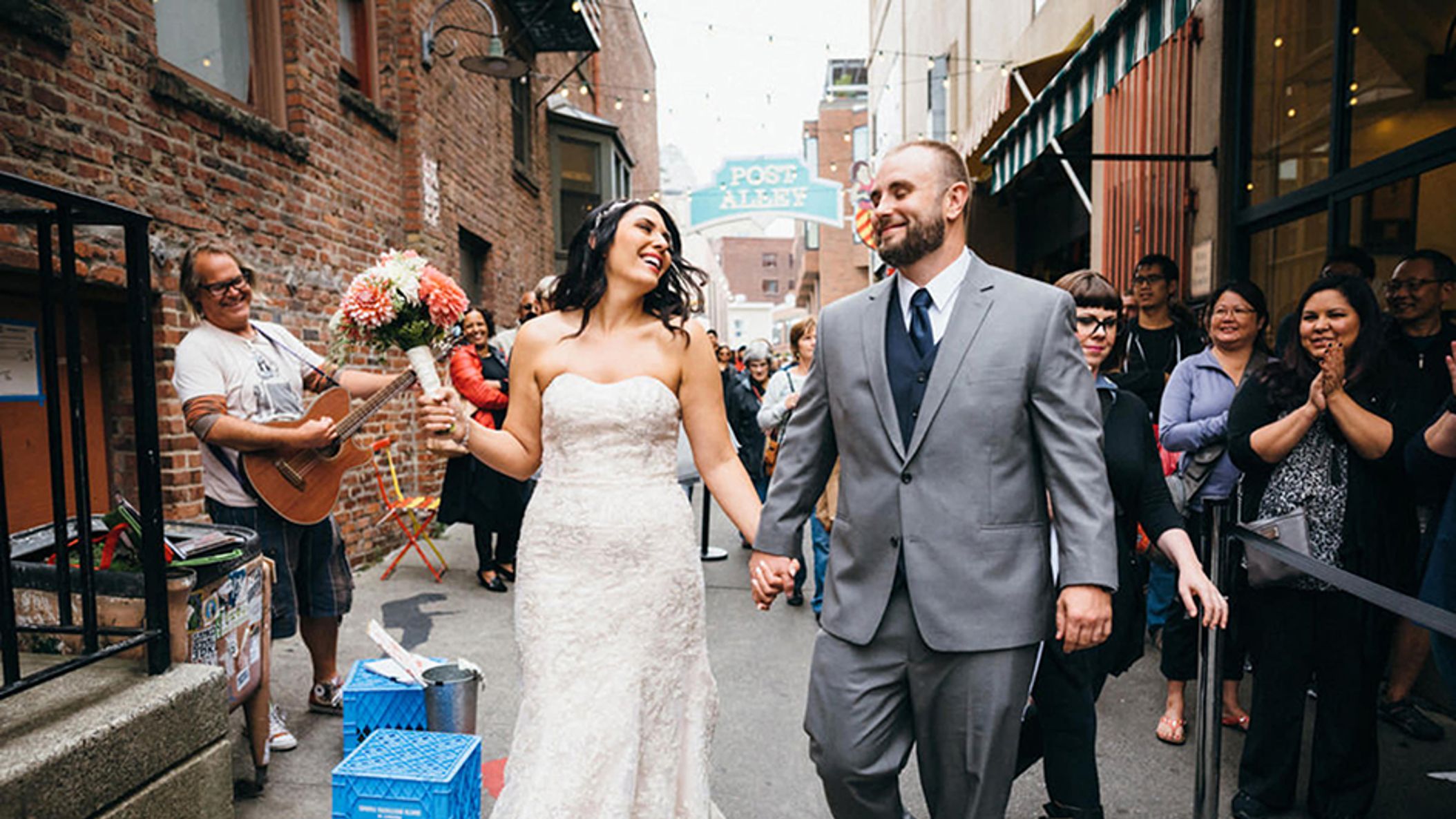 inline-images/bride-and-groom-walking-through-pike-place-market-seattle-wedding-photographers-jenn-tai-co (1).jpg