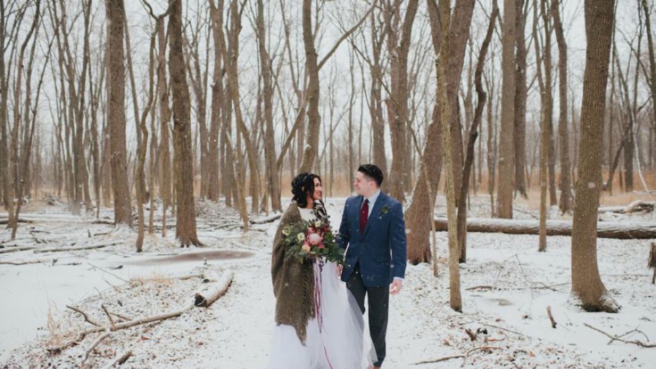 Wisconsin_Bride/StyledWinterShootMonicaCPhoto/866x578px.winter_bride_with_brown_cloak_walking_with_groom_in_navy_suit_WEB.jpg