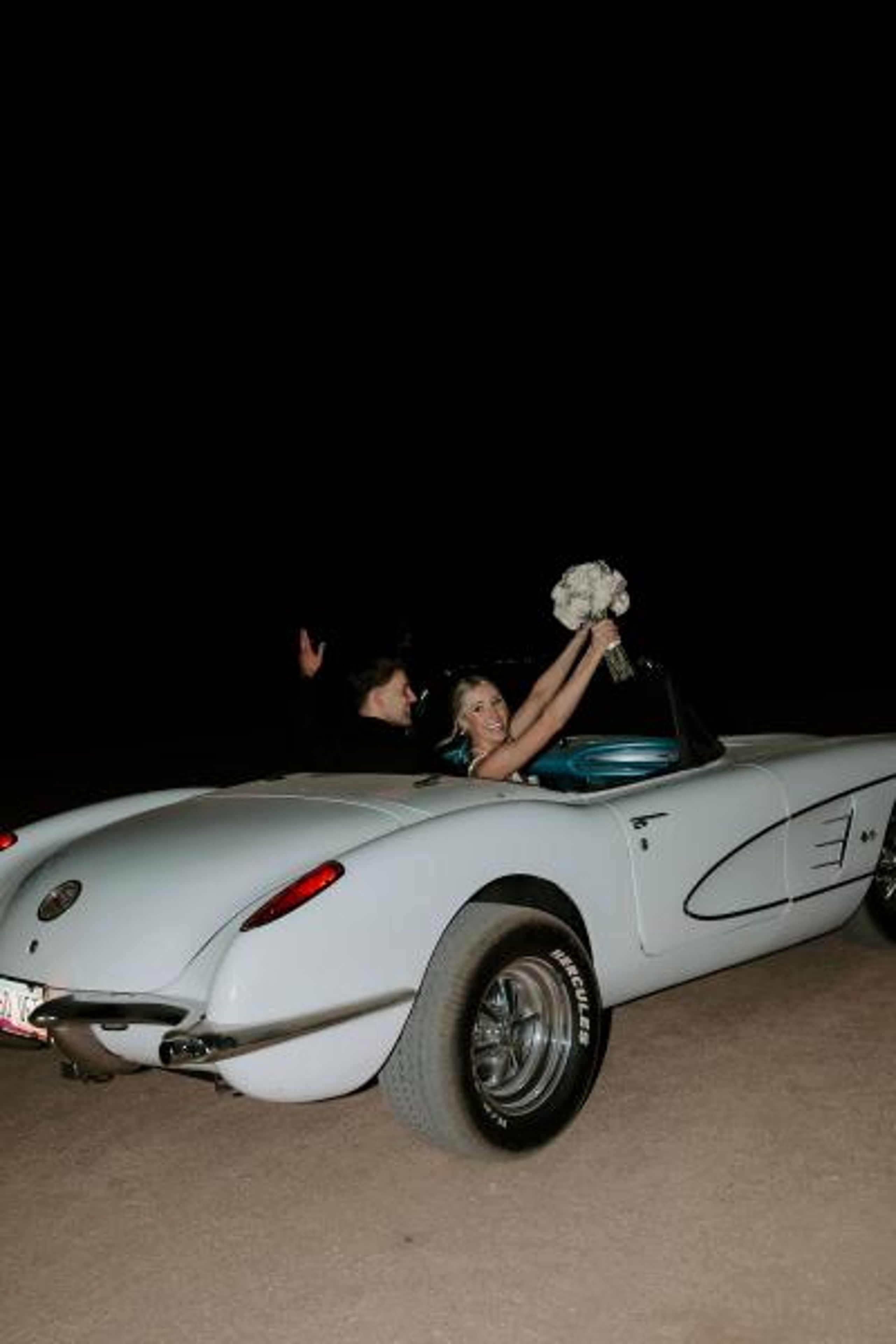 Madison and Sam in their vintage getaway car
