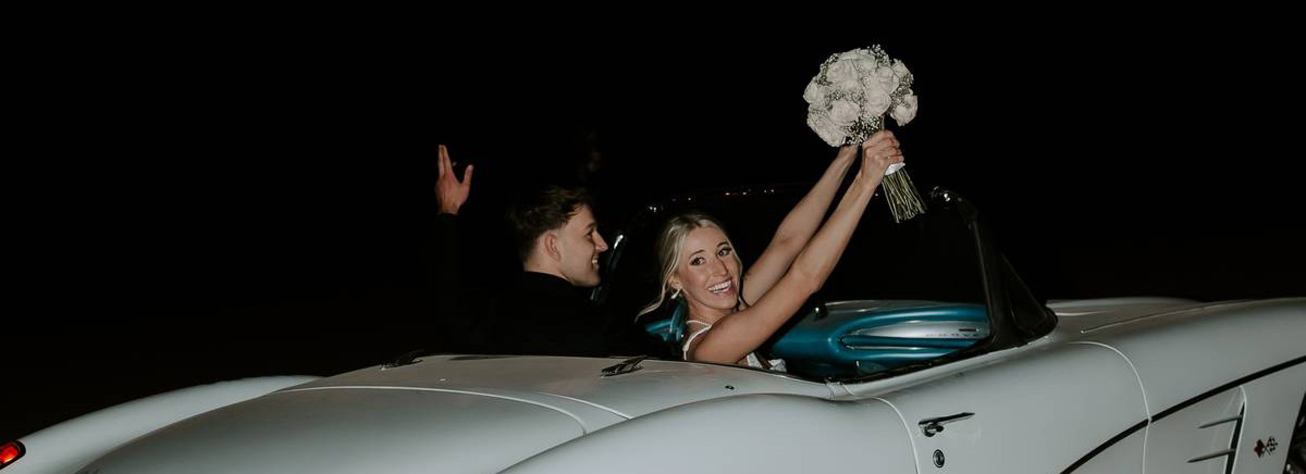 Madison and Sam in their vintage getaway car