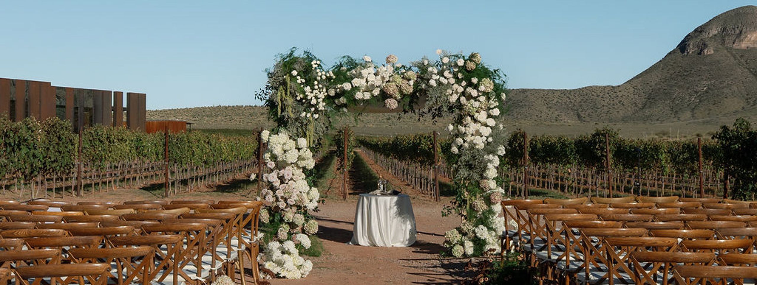 Lush chuppah sits on grounds of Los Milics Vineyards in outdoor ceremony