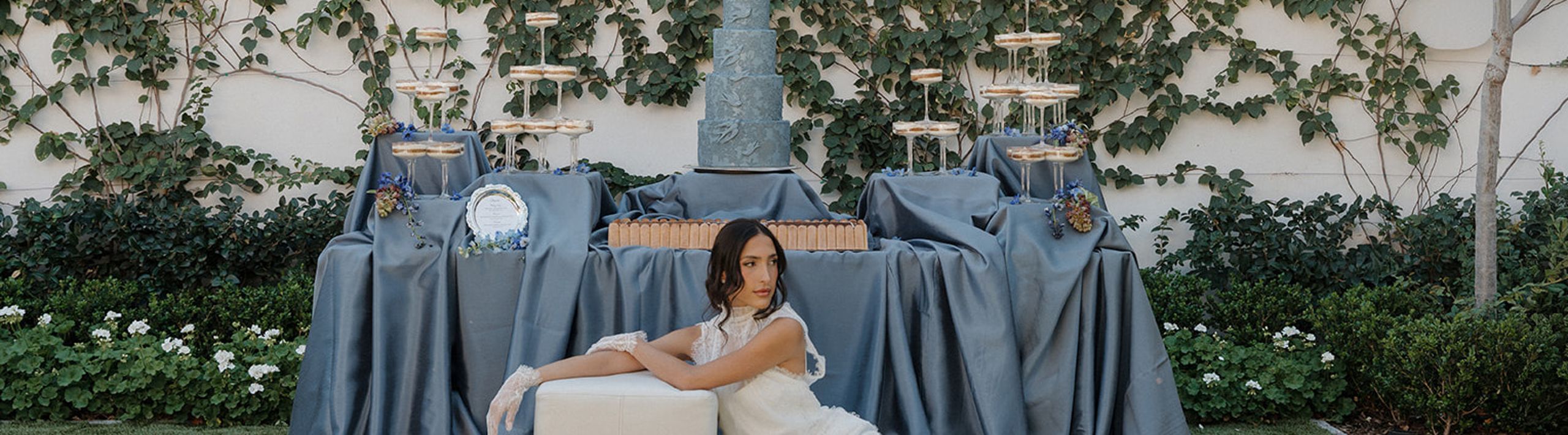 Model poses in front of a dessert table