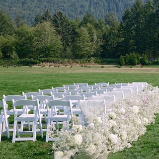 Outdoor ceremony with airy florals at North Fork Farms