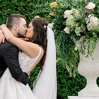 Paige and Nick seal their vows with a kiss in outdoor ceremony at Columbia Collective