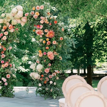 Ceremony set up featuring floral arch in the center