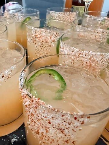 Wedding cocktails served over ice with seasoned rims and fresh jalapeño slices.