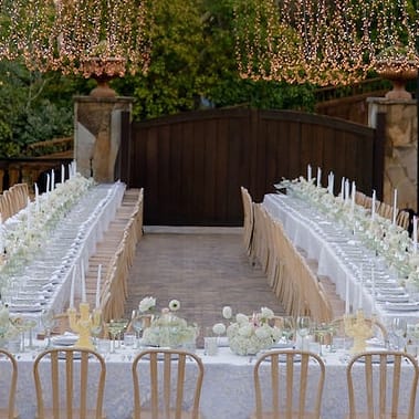 Outdoor reception scene with simple white décor at Private Residence