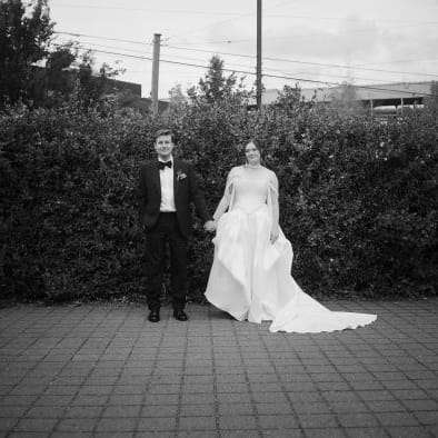 Allie and Max pose side by side on their wedding day